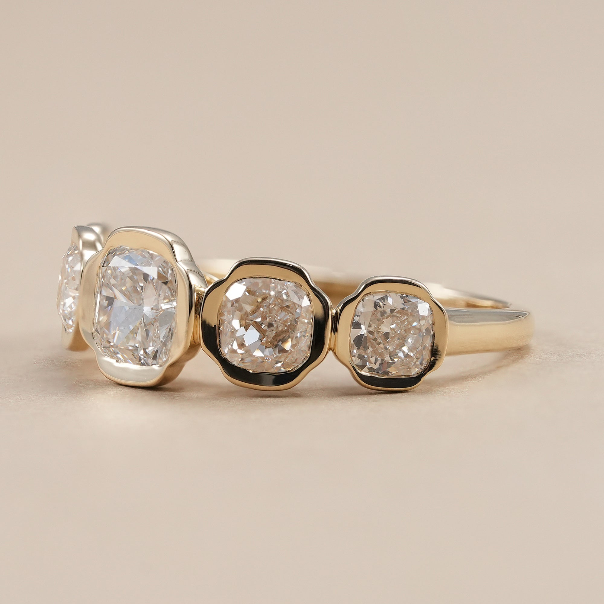 Bezel set cushion cut lab grown diamond wedding band in polished gold.