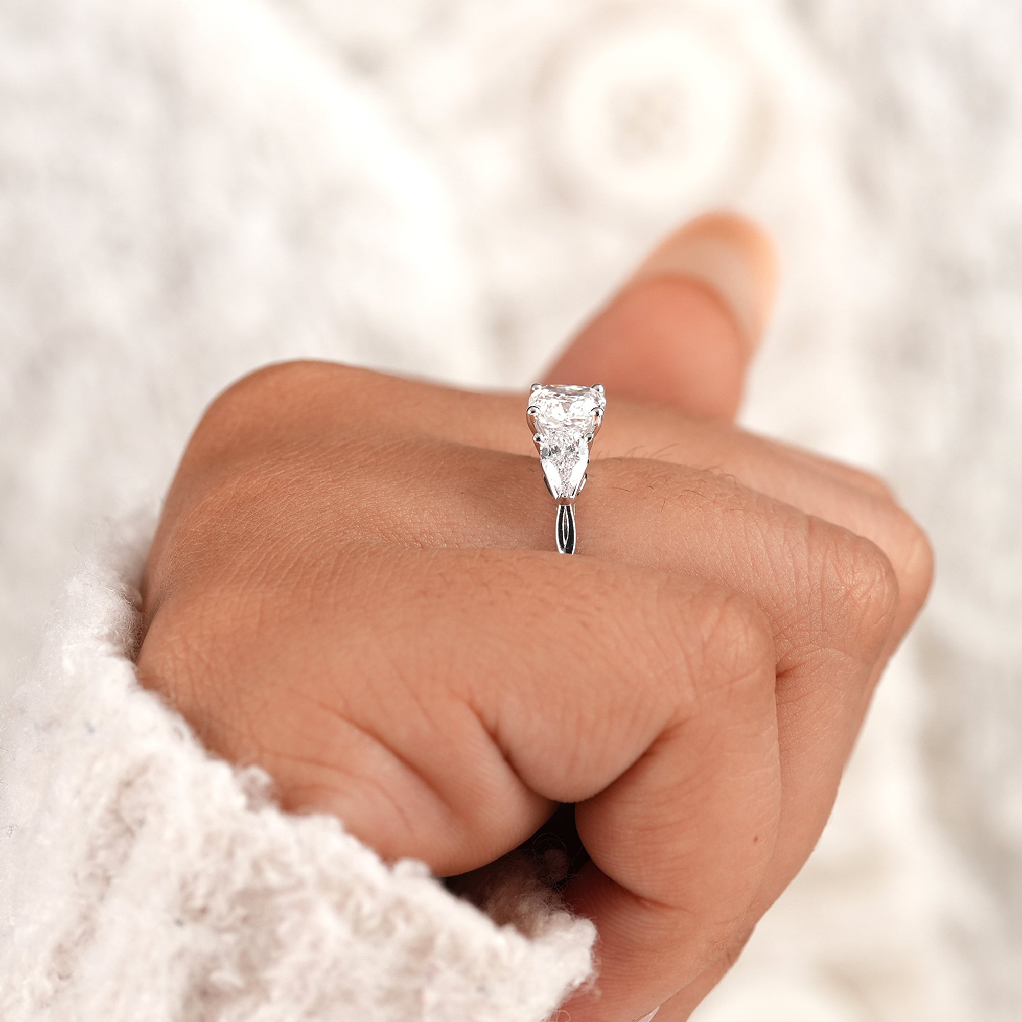 Sustainable cushion lab diamond engagement ring on finger