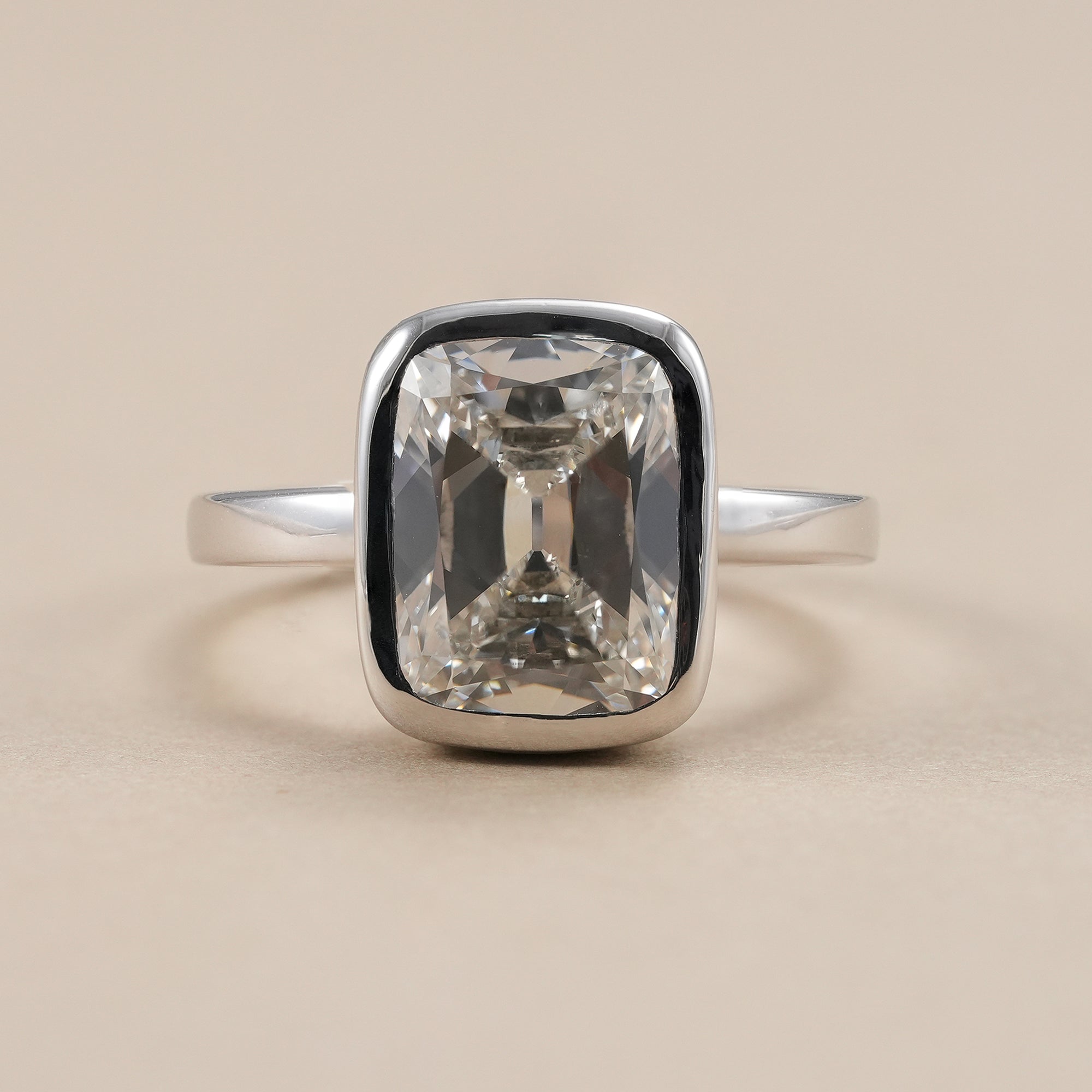 Cushion lab diamond ring with bezel setting and hidden halo.