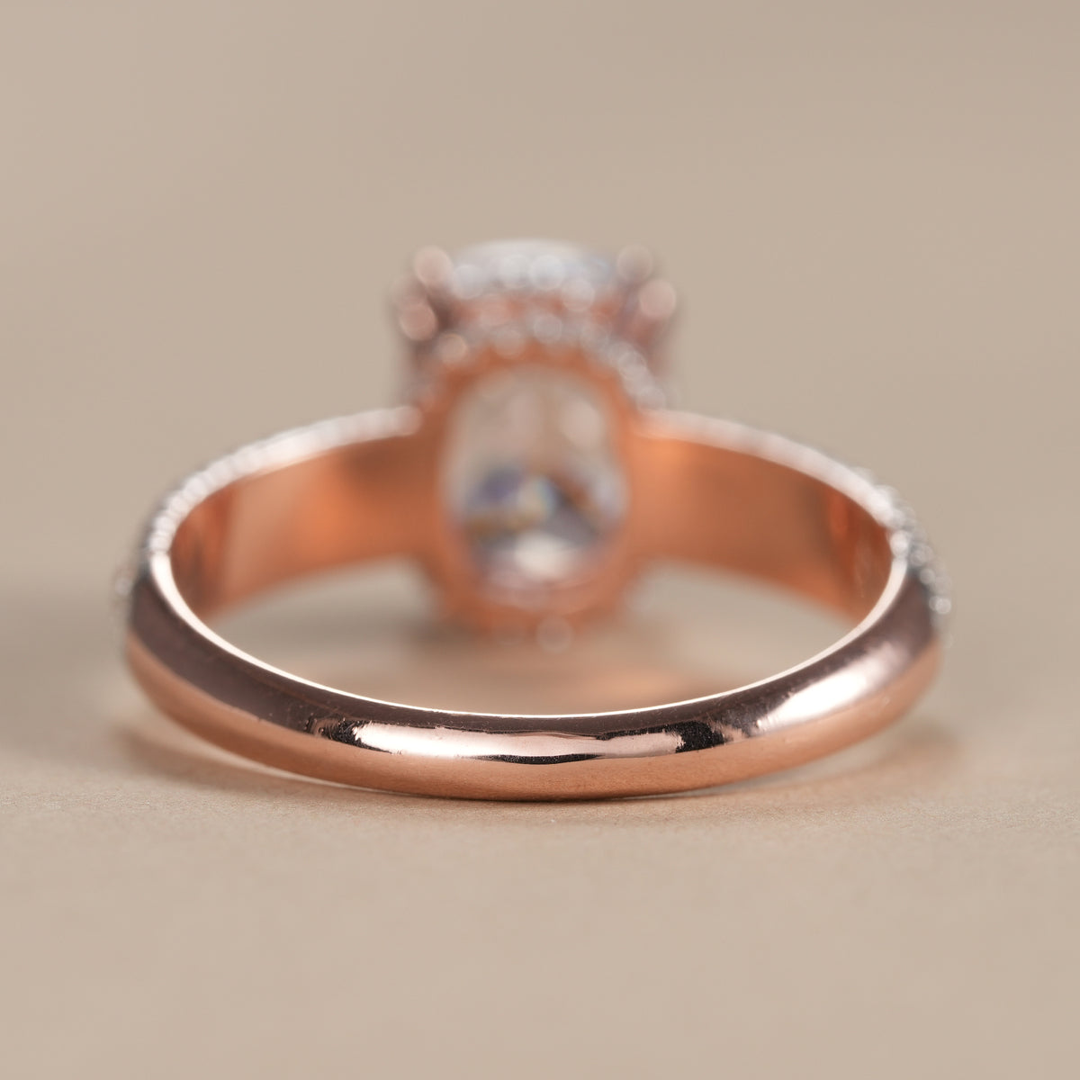 Cushion cut solitaire engagement ring with shimmering pavé band and hidden halo inspired gallery.