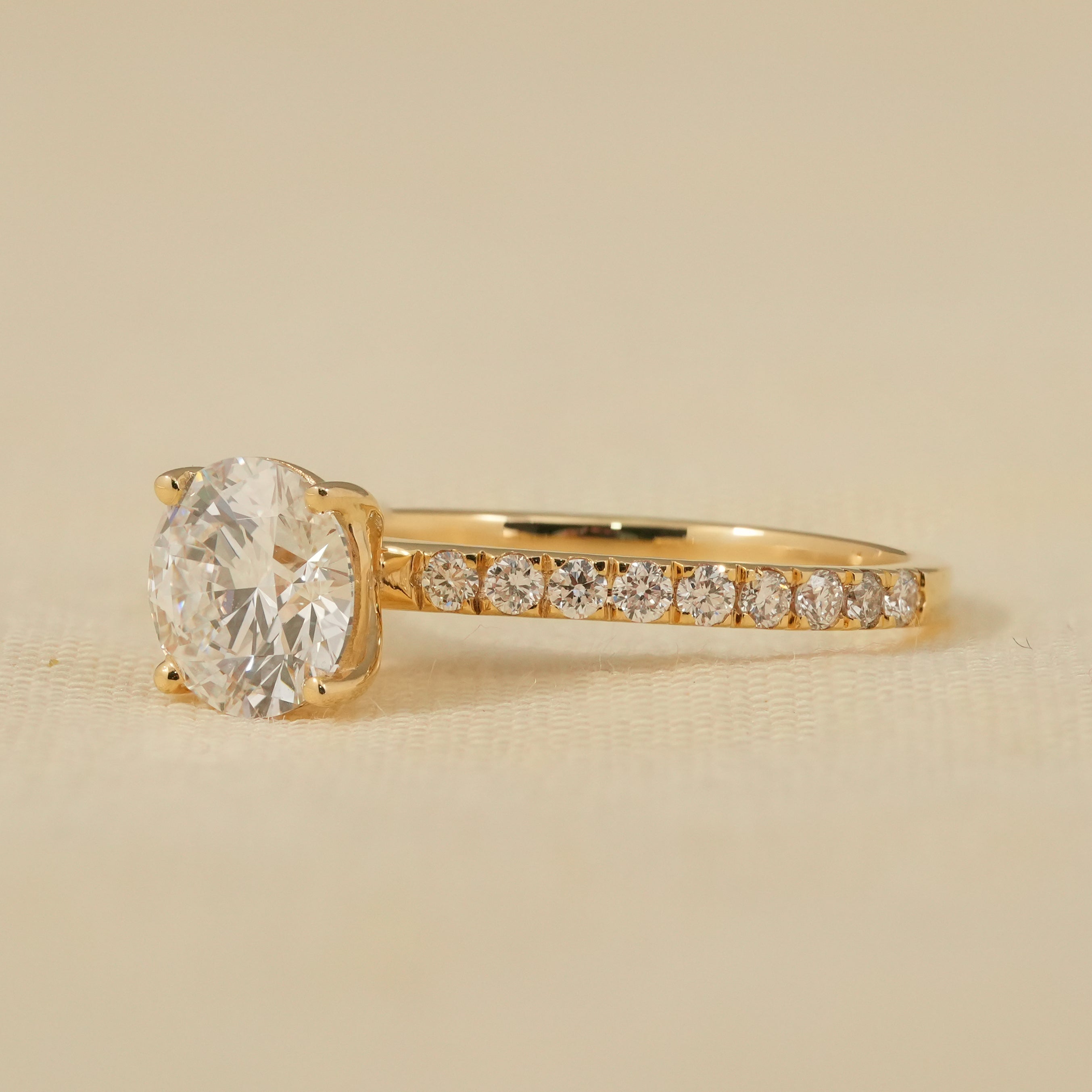 Luxury lab grown diamond round cut ring showcasing pavé side stones