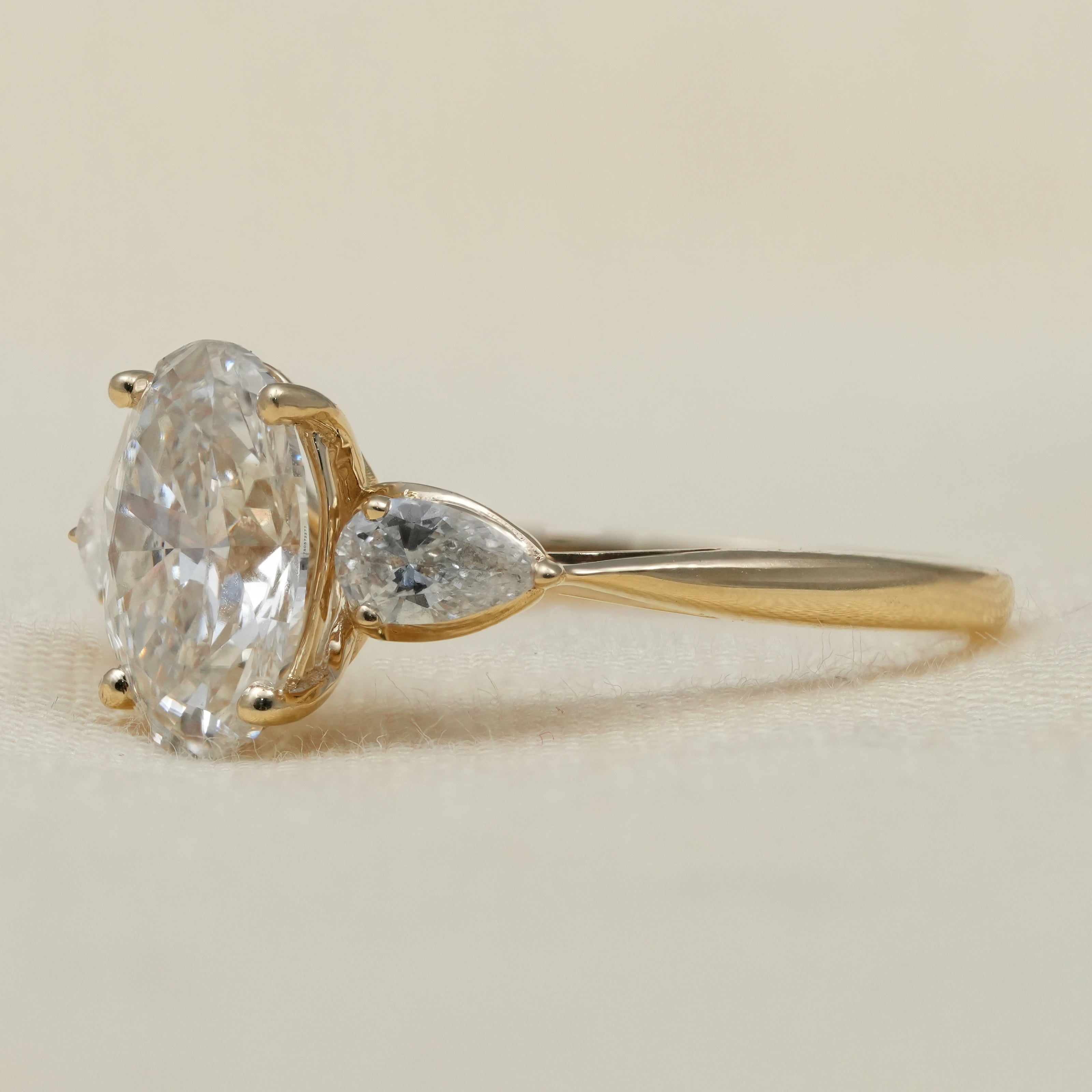Oval lab grown diamond ring with pear side stones engagement style