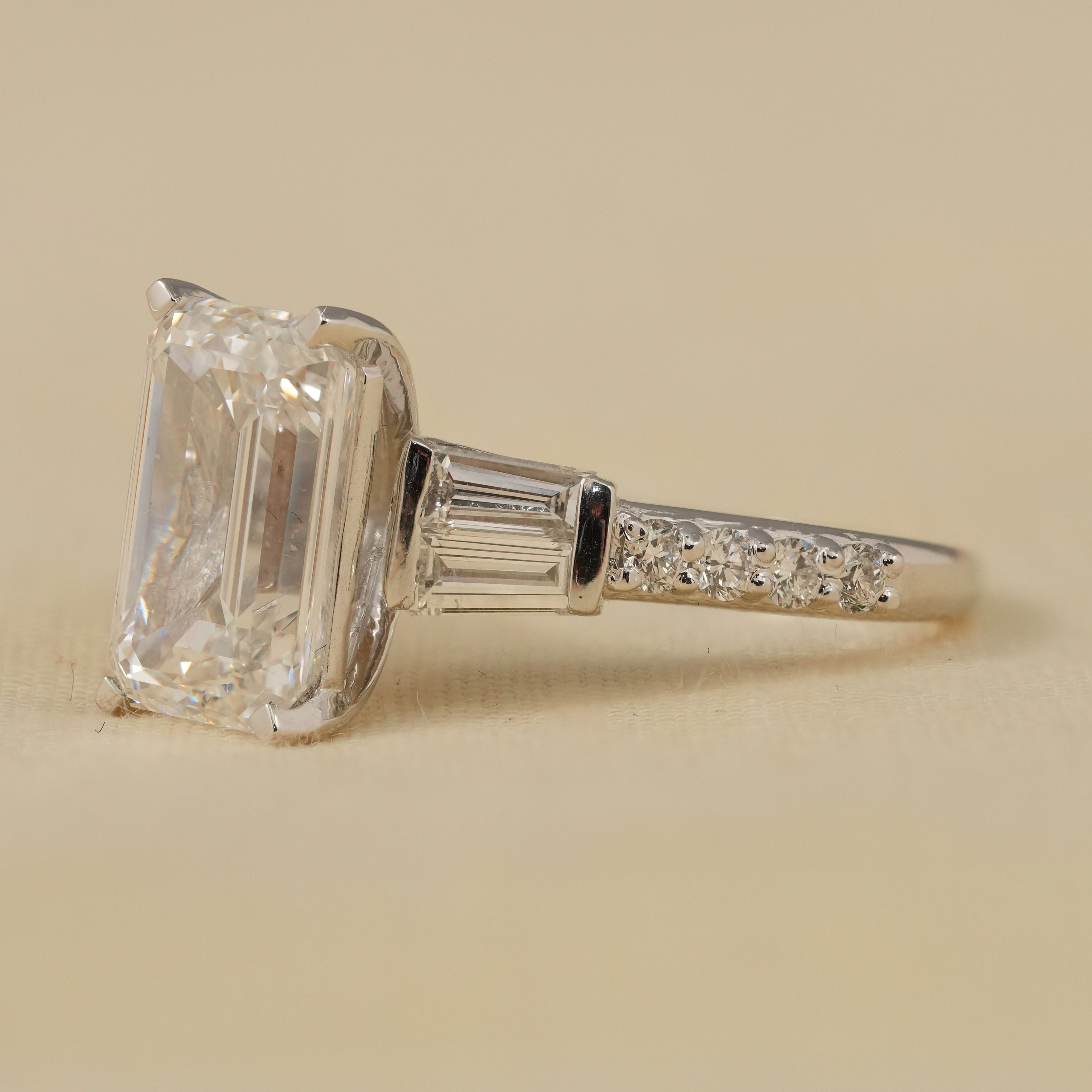 Elegant lab grown diamond engagement ring with emerald cut center and tapered baguette accents