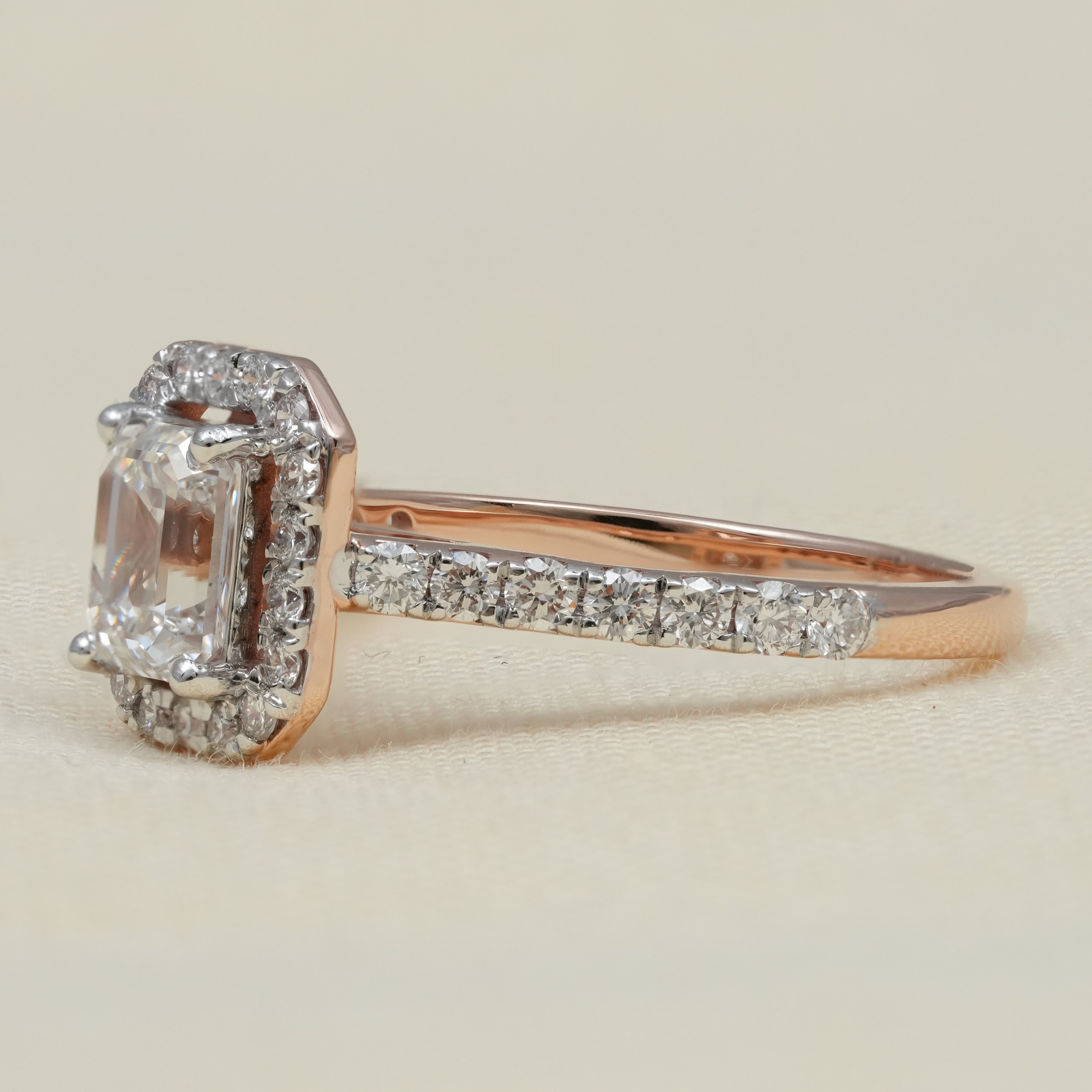 Elegant halo engagement ring with emerald cut lab grown diamond center