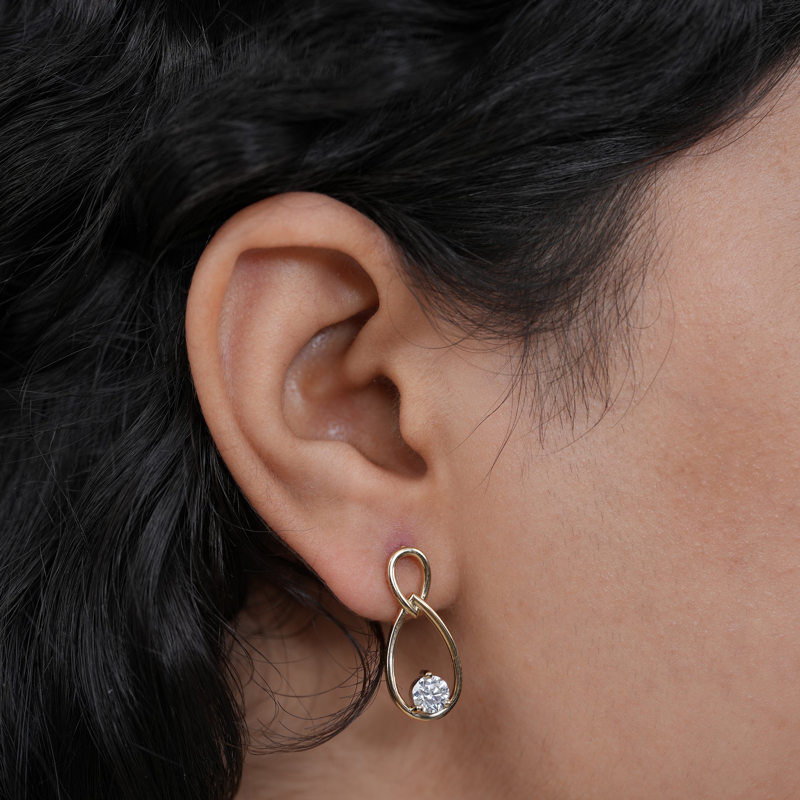 Delicate teardrop gold earrings with brilliant diamond drops