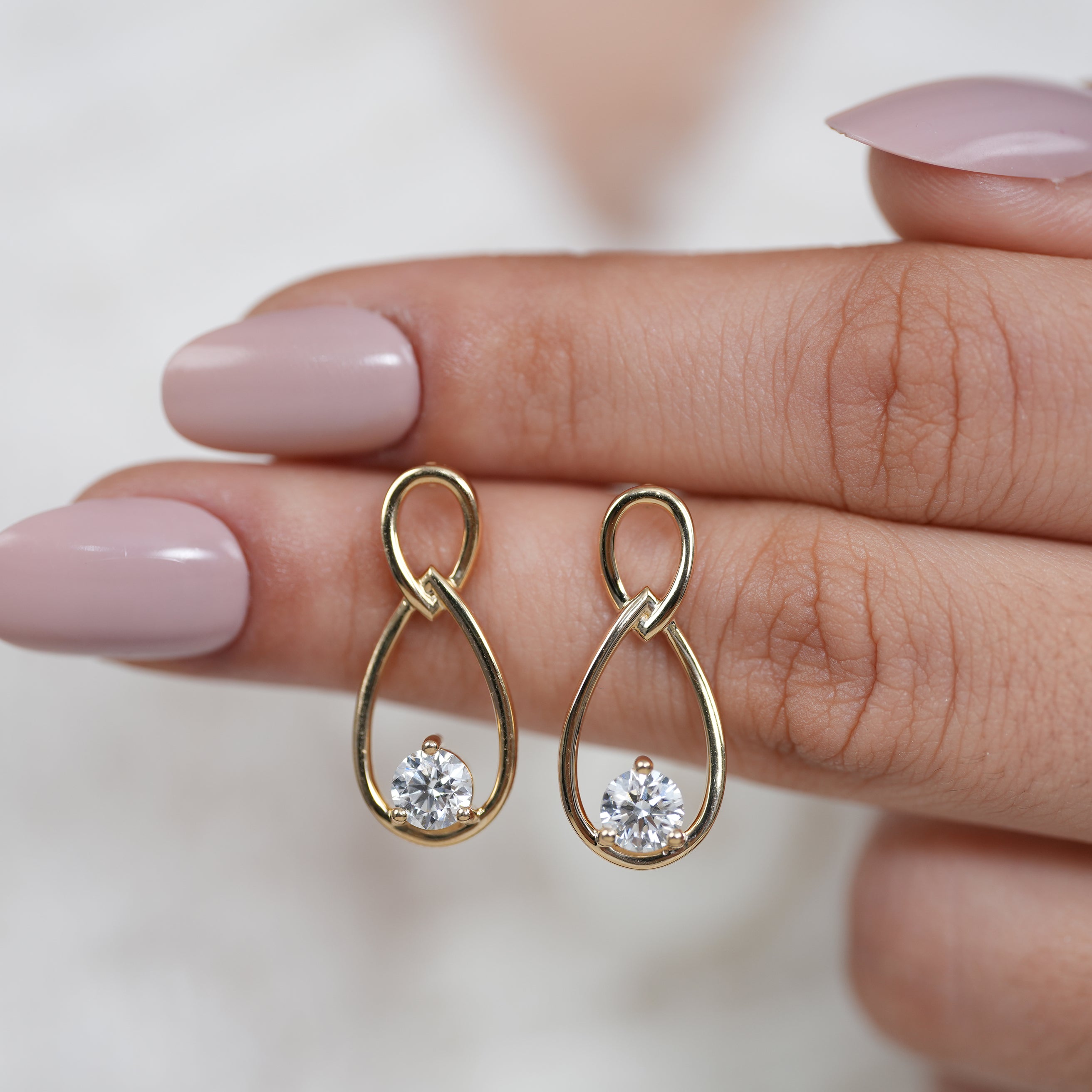 Modern yellow gold drop earrings with floating round diamonds