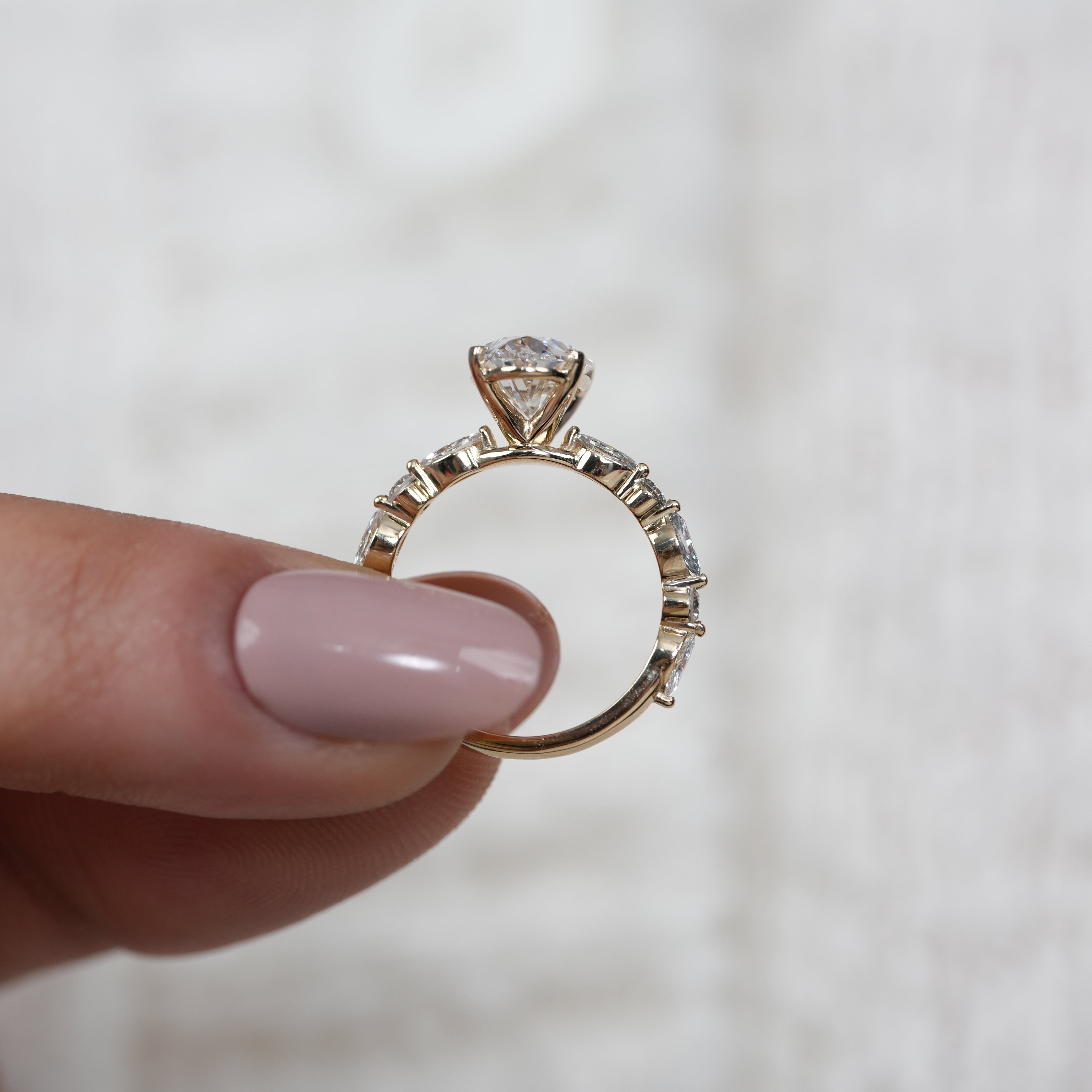 Oval lab grown diamond ring accented with marquise stones, refined look