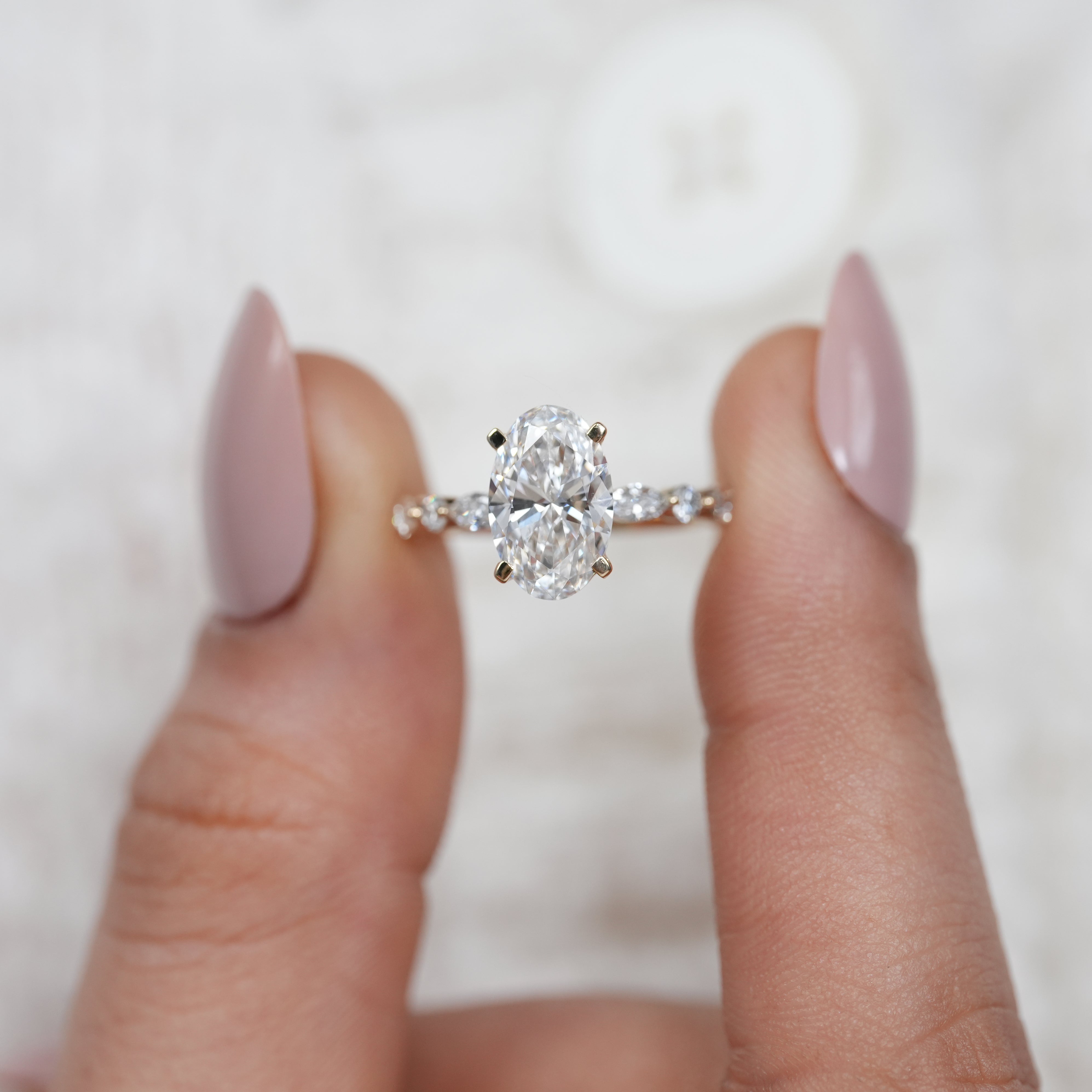 Elegant oval diamond ring featuring lab grown diamond side accents