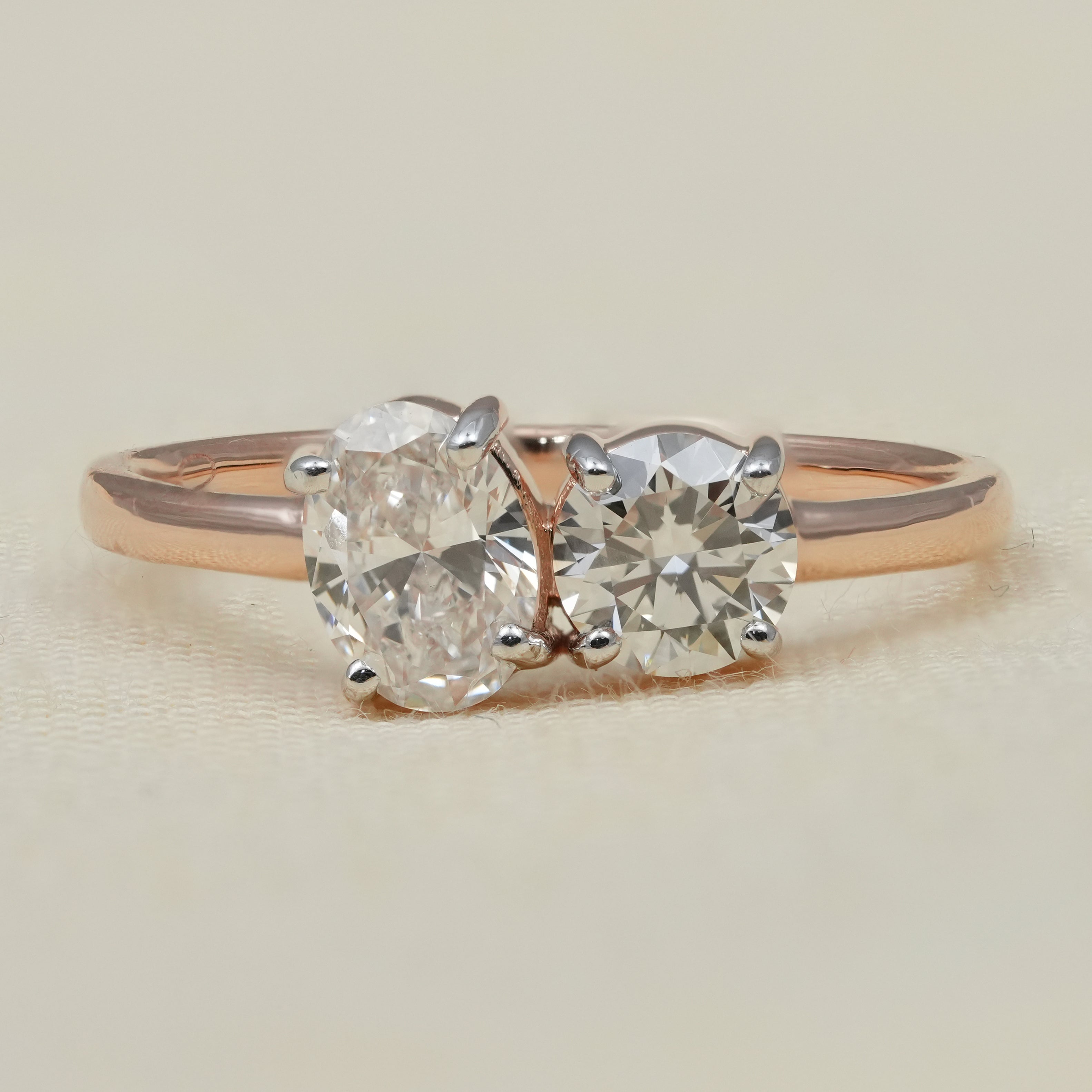 Two stone ring featuring oval and round lab grown diamonds