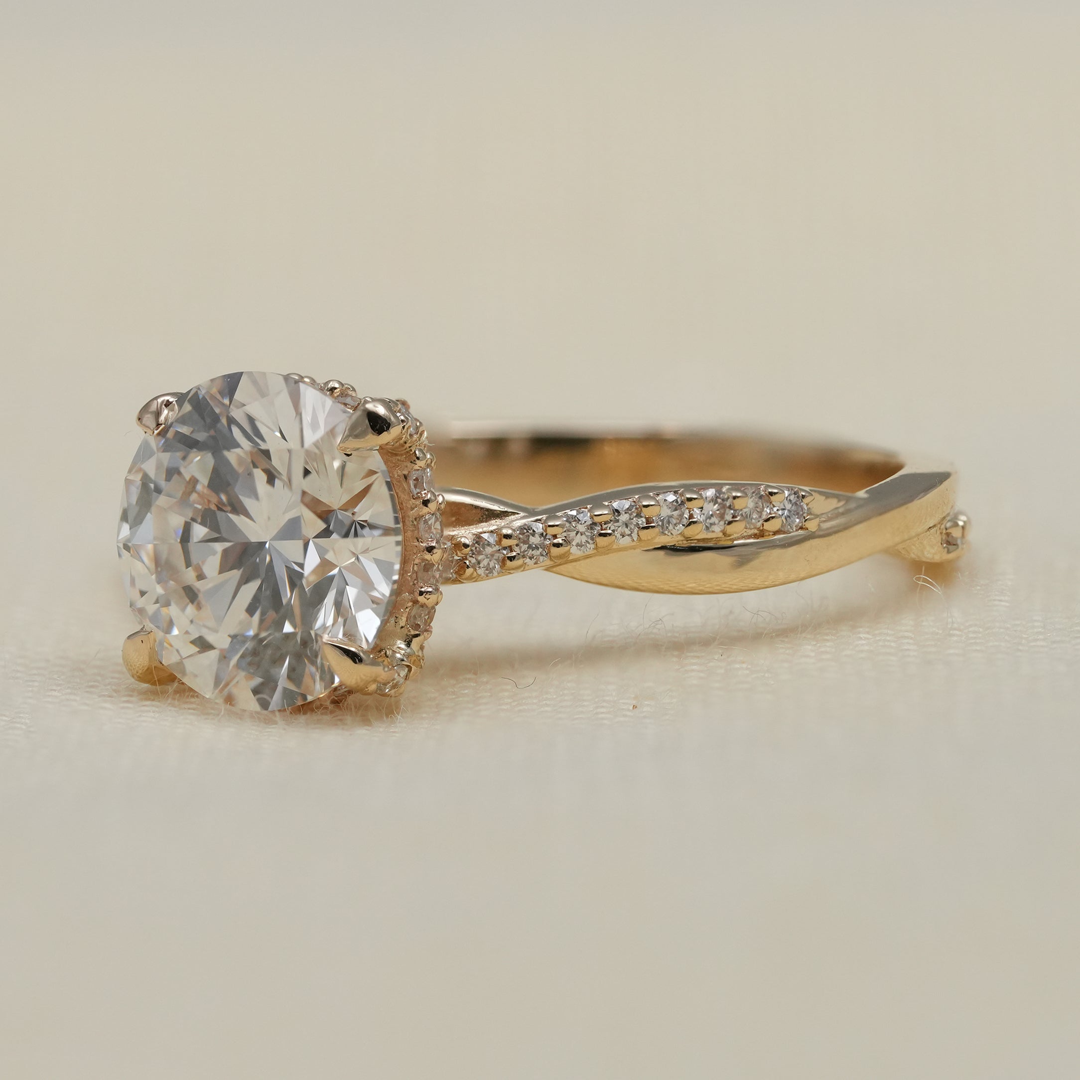 Round lab grown diamond solitaire with crossover gold band