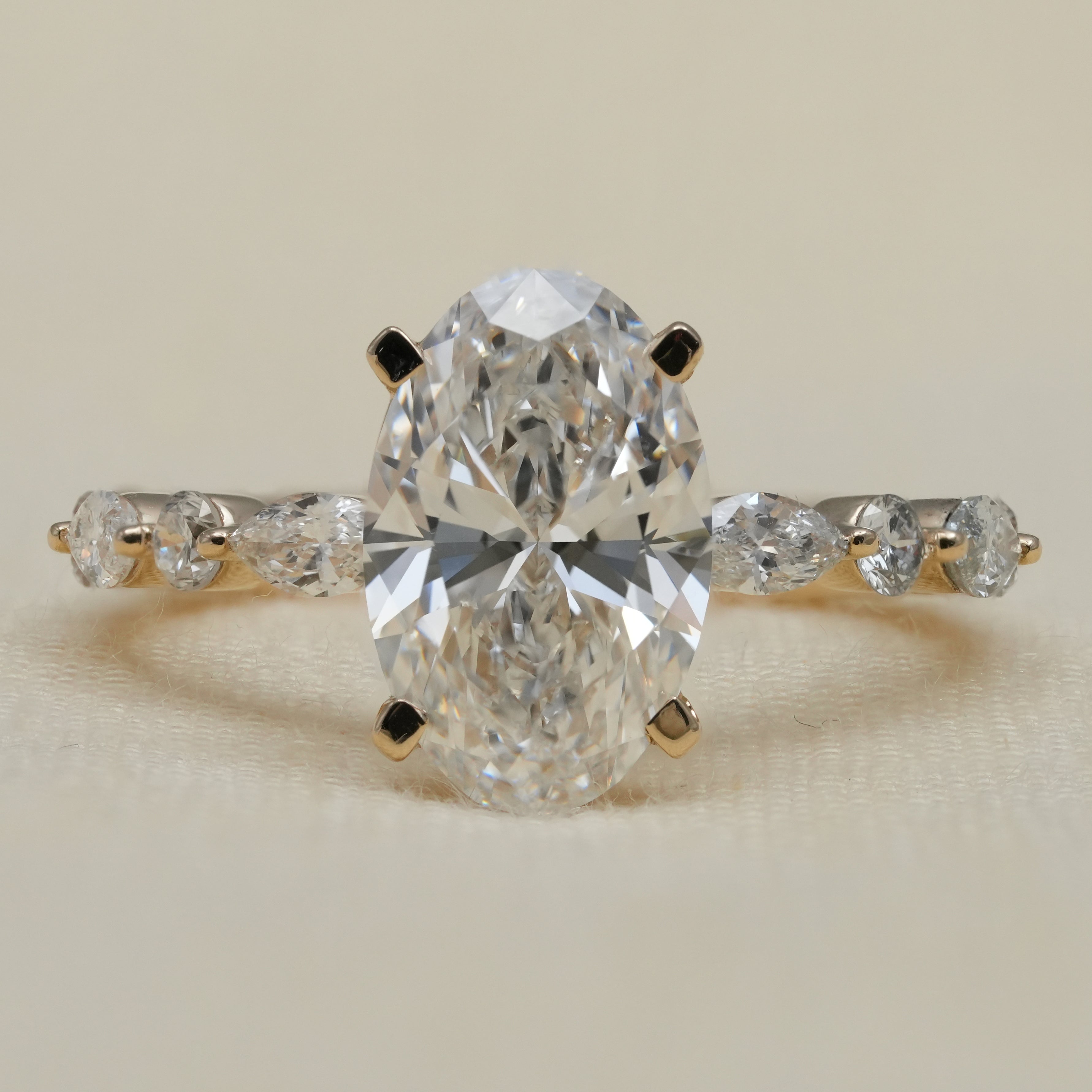 Oval lab grown diamond ring with marquise side stones, elegant gift