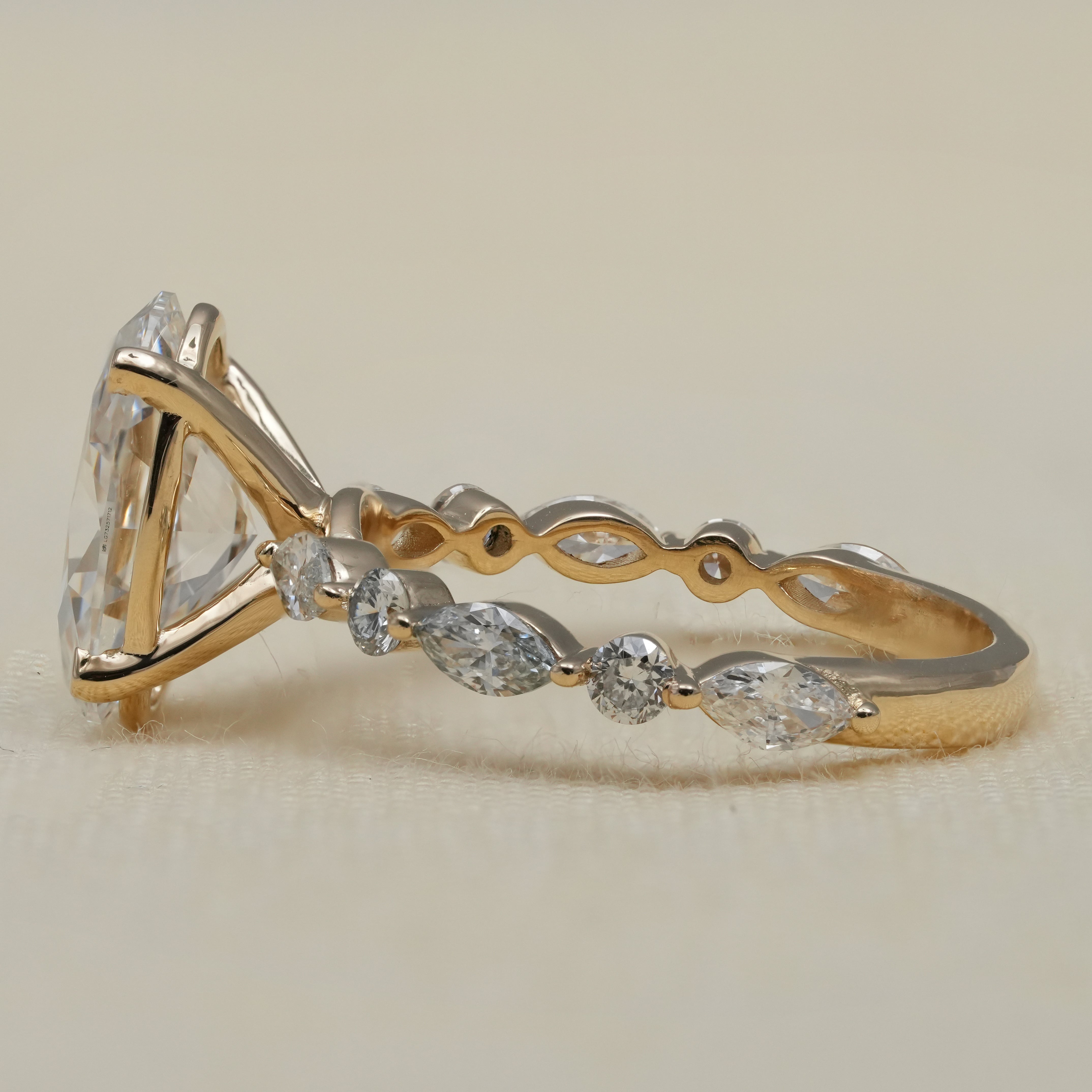 Oval diamond engagement ring with lab grown diamond marquise details