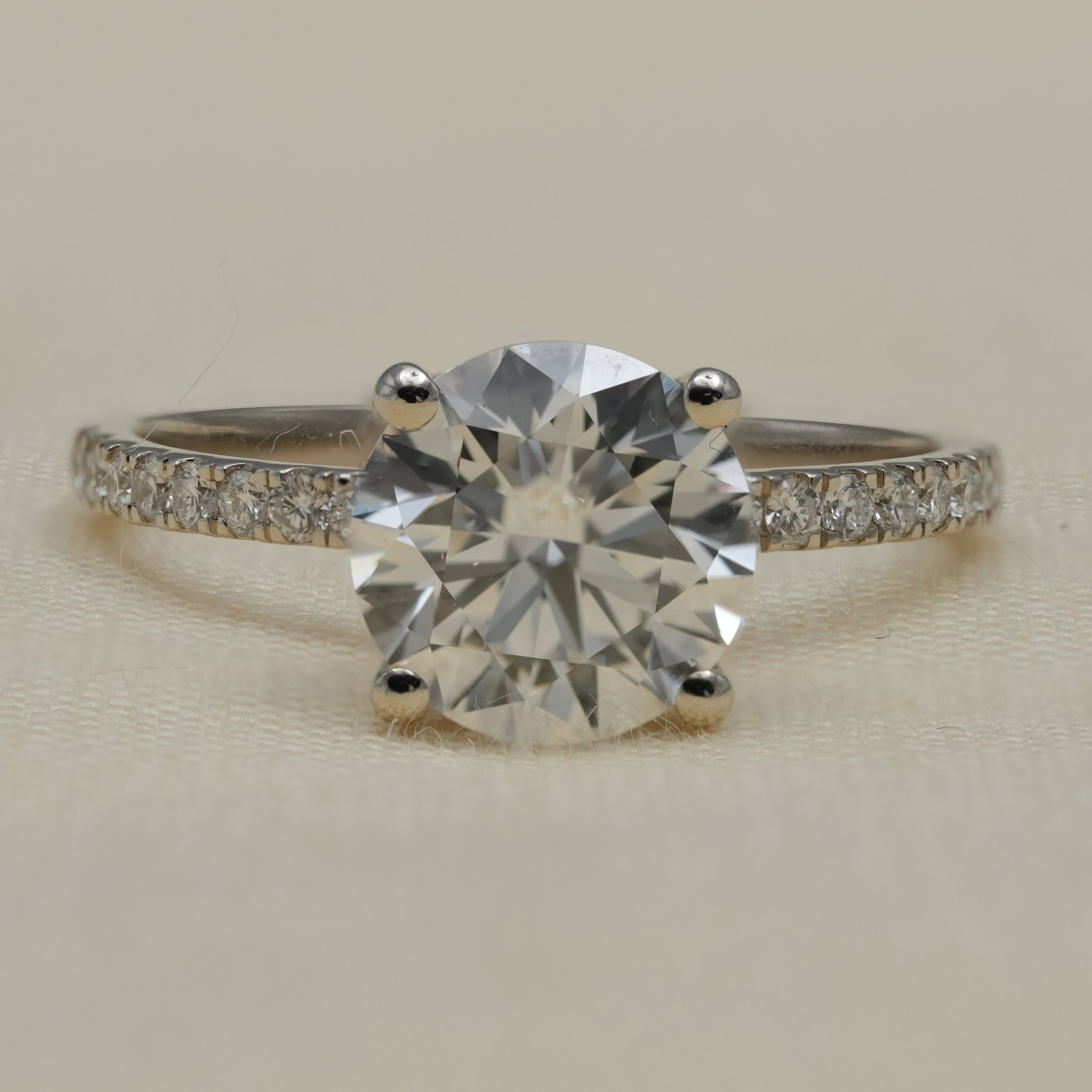 Round lab grown diamond solitaire engagement ring with pavé band