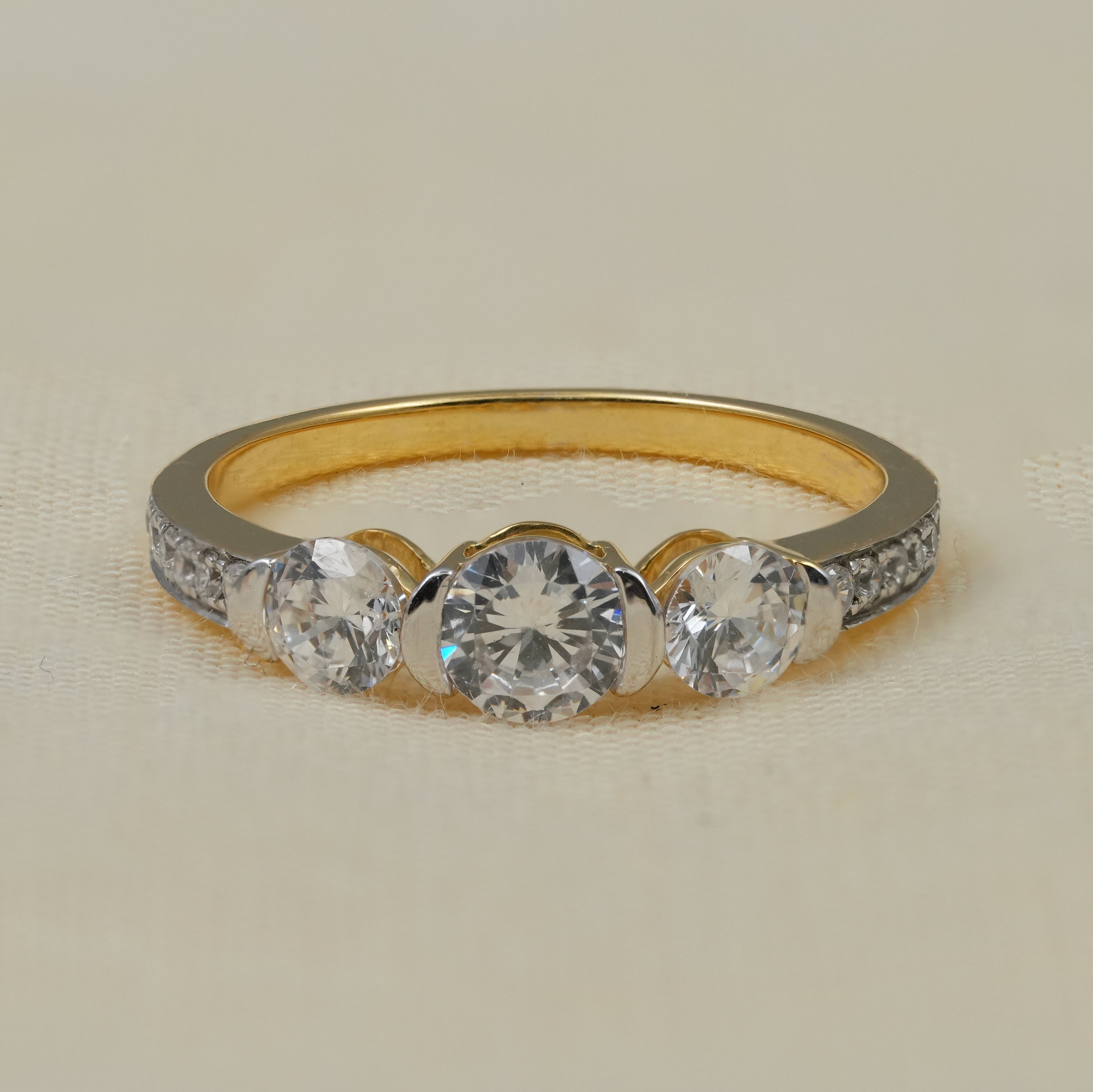 Three stone round lab grown diamond engagement ring yellow gold band