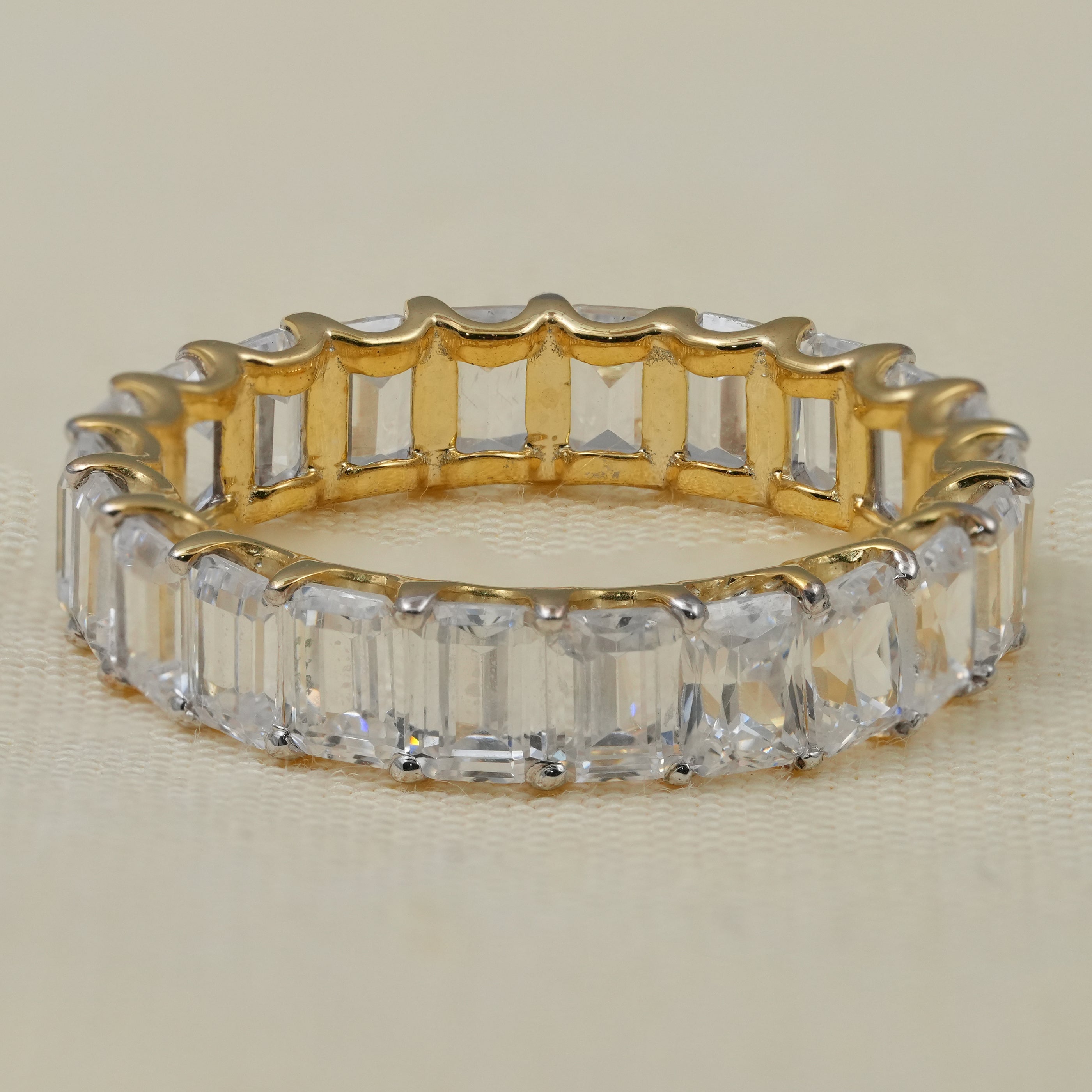Emerald cut lab grown diamond eternity band in yellow gold