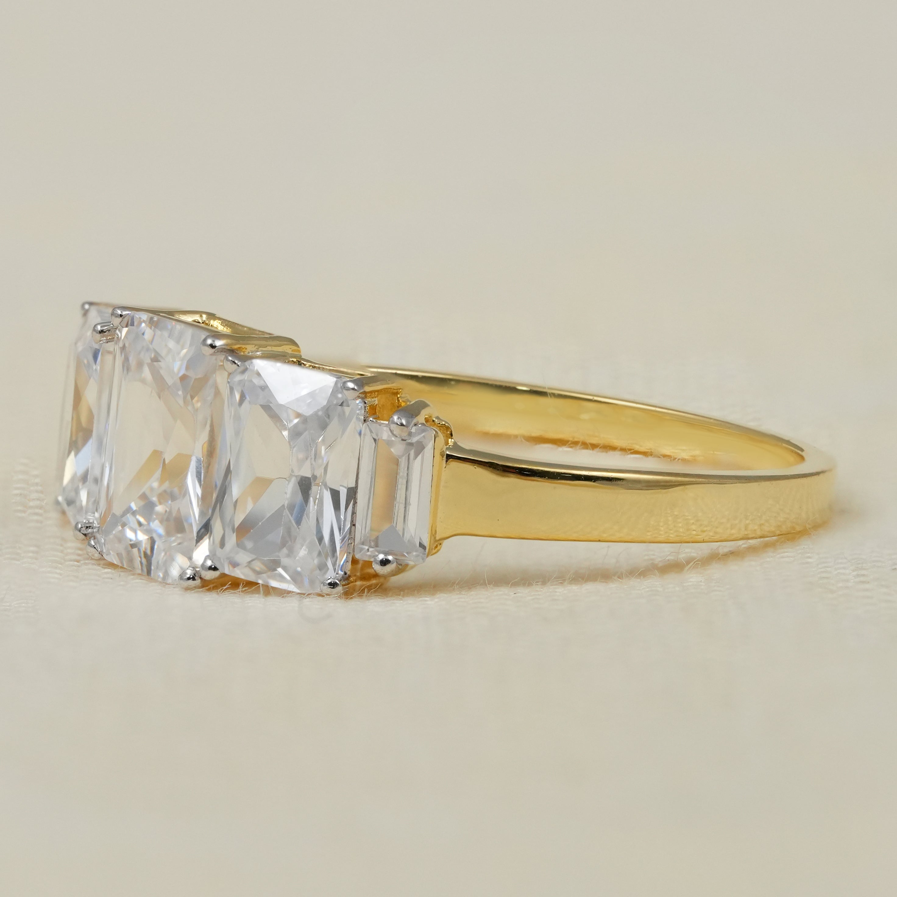 Modern three stone radiant lab grown diamond ring with gold band
