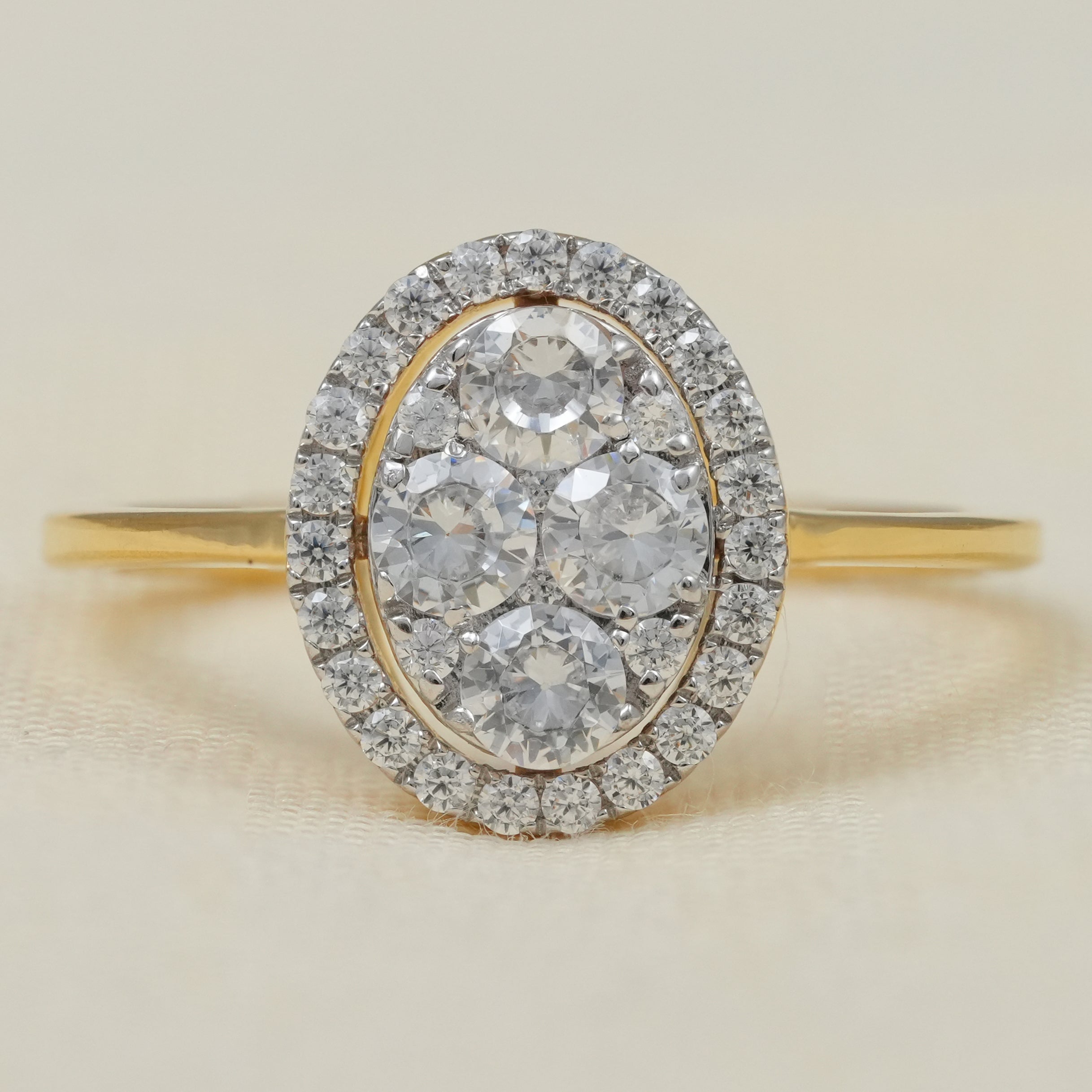 Oval halo cluster engagement ring with lab grown diamonds in yellow gold