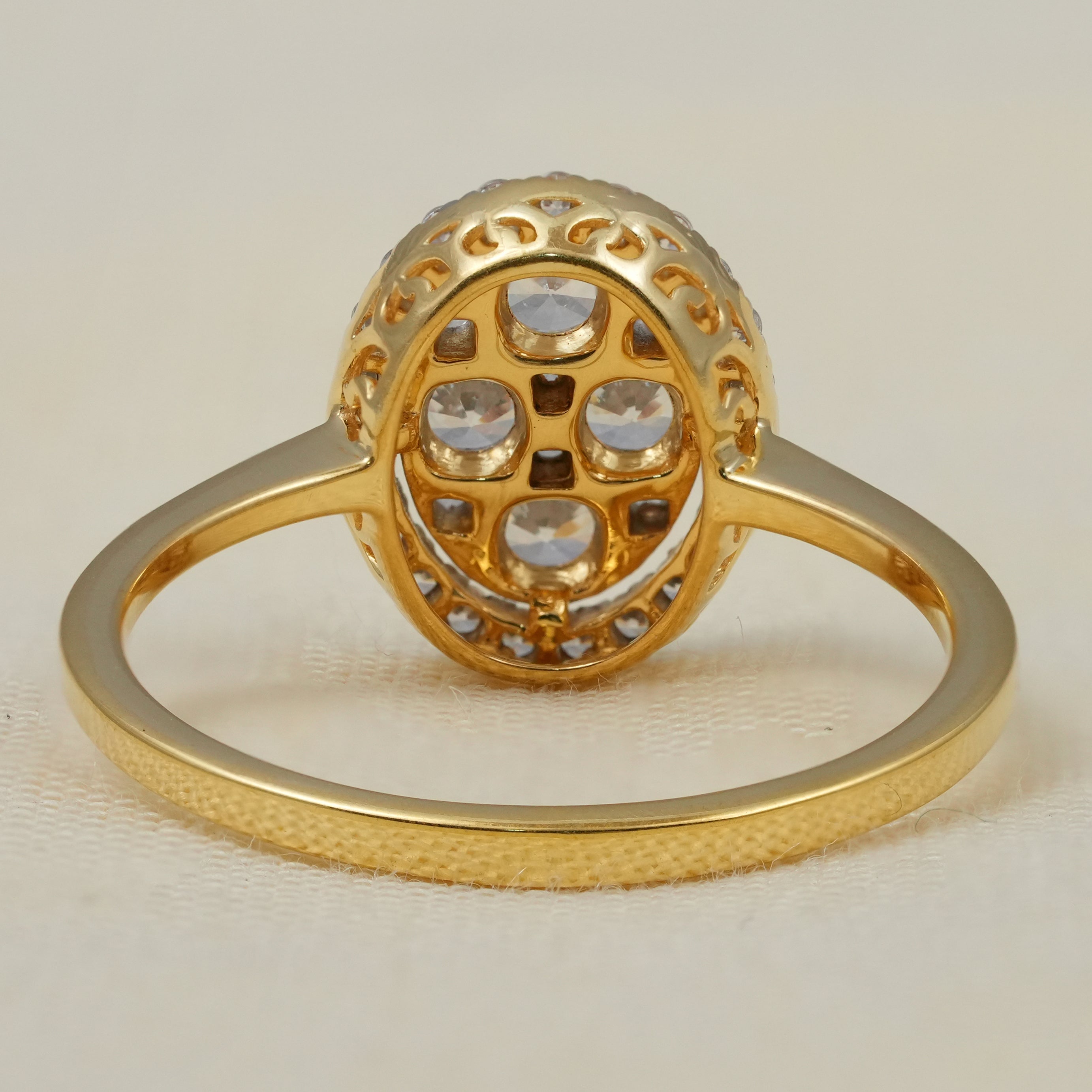 Oval halo engagement ring with sparkling lab grown diamond cluster