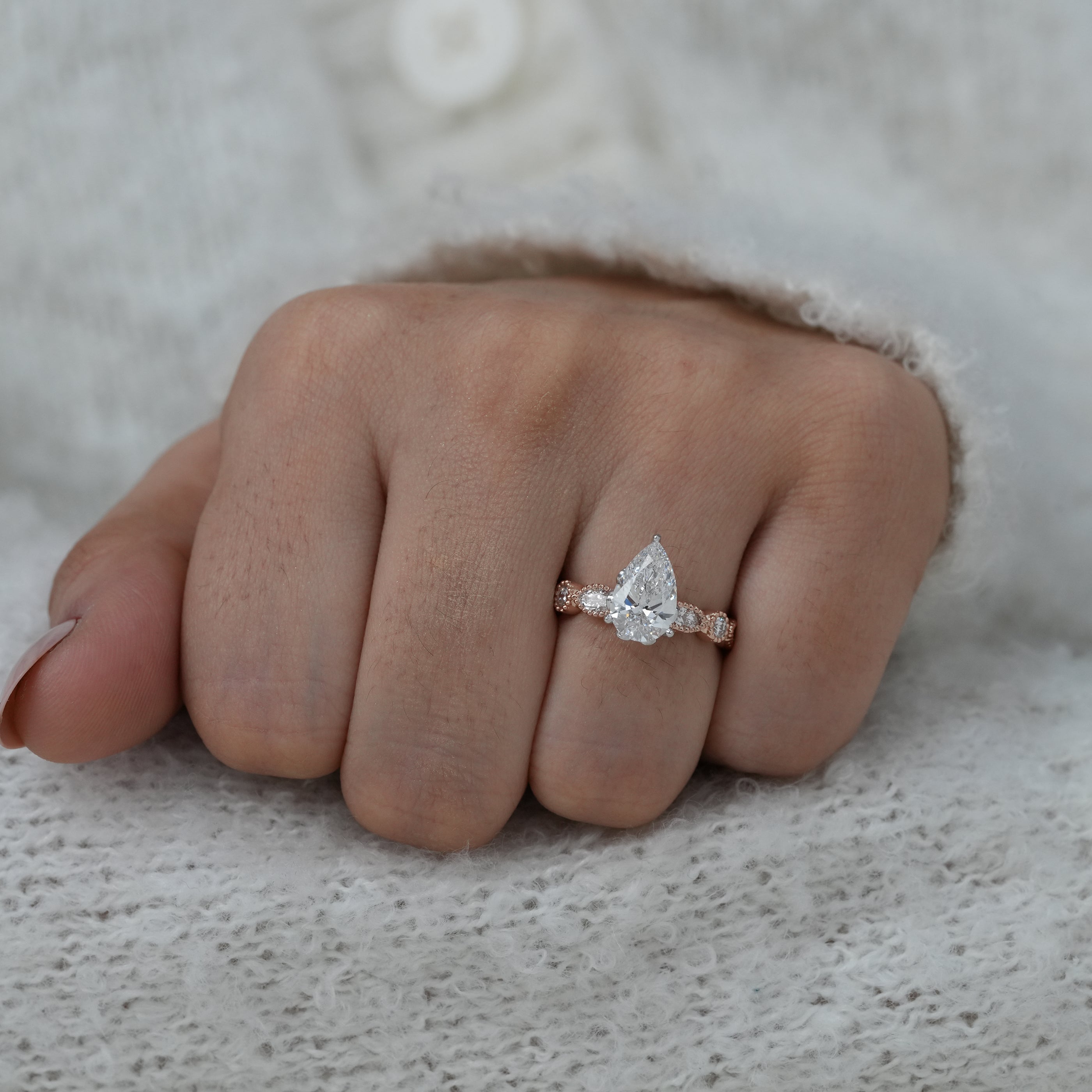 Pear lab grown diamond bridal ring with marquise side sparkle