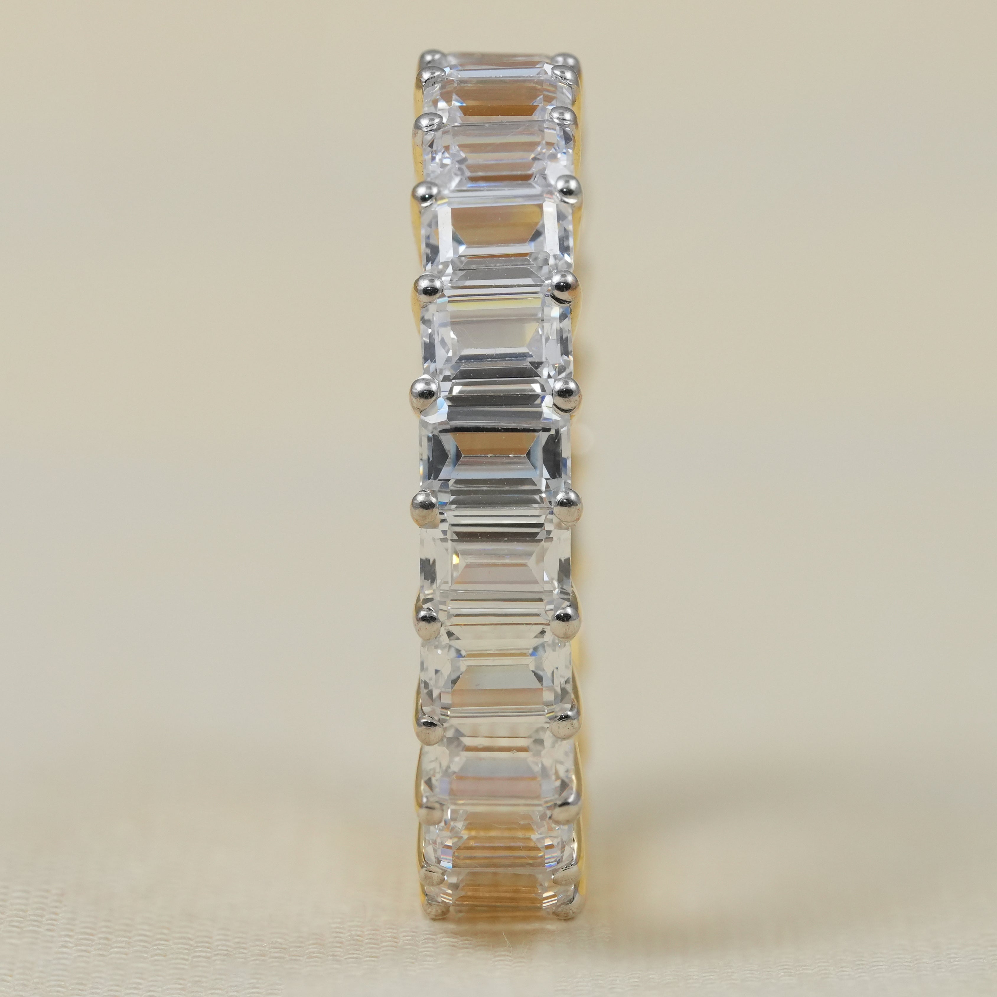 Full eternity band featuring emerald cut lab grown diamonds