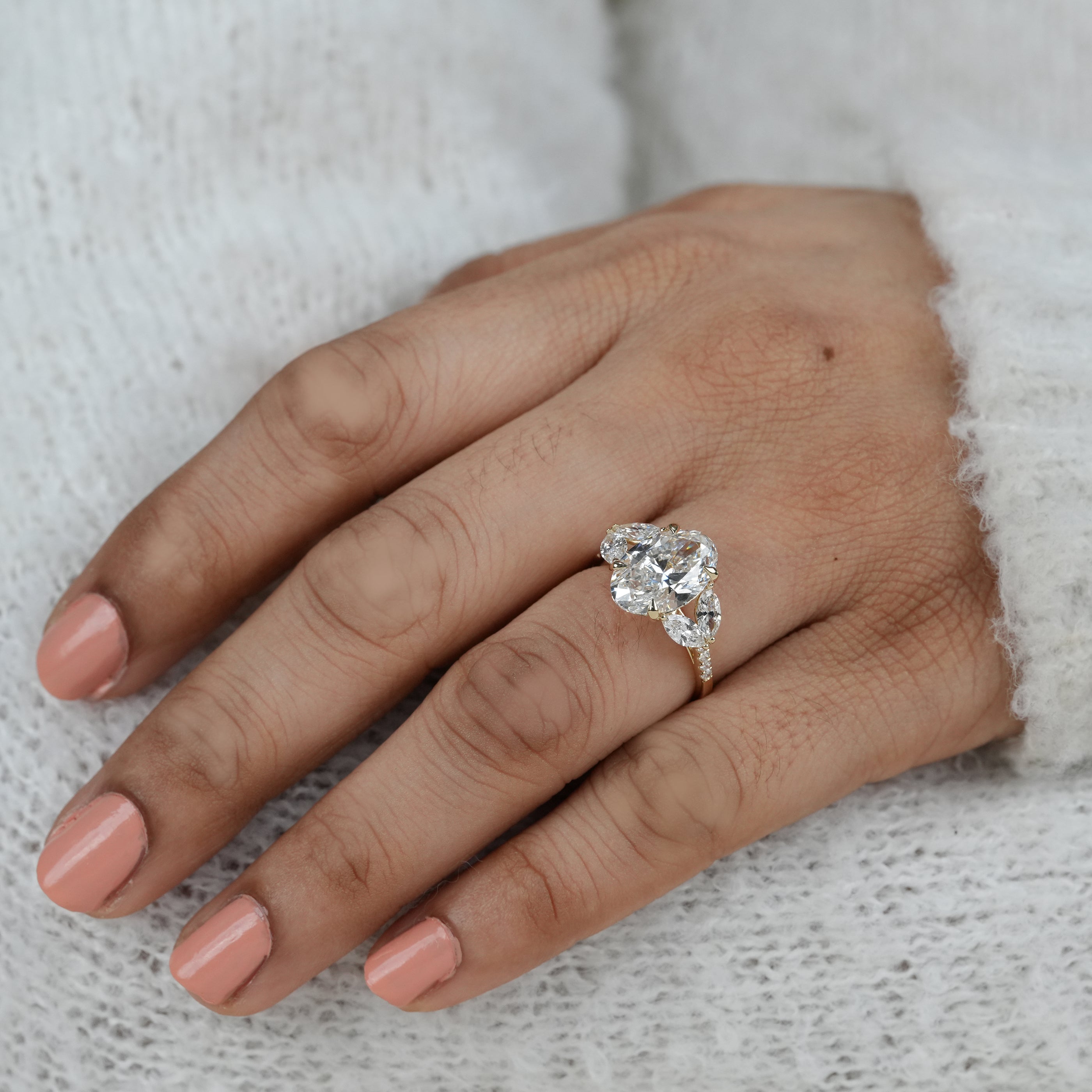Close up oval lab grown diamond ring with marquise side stones