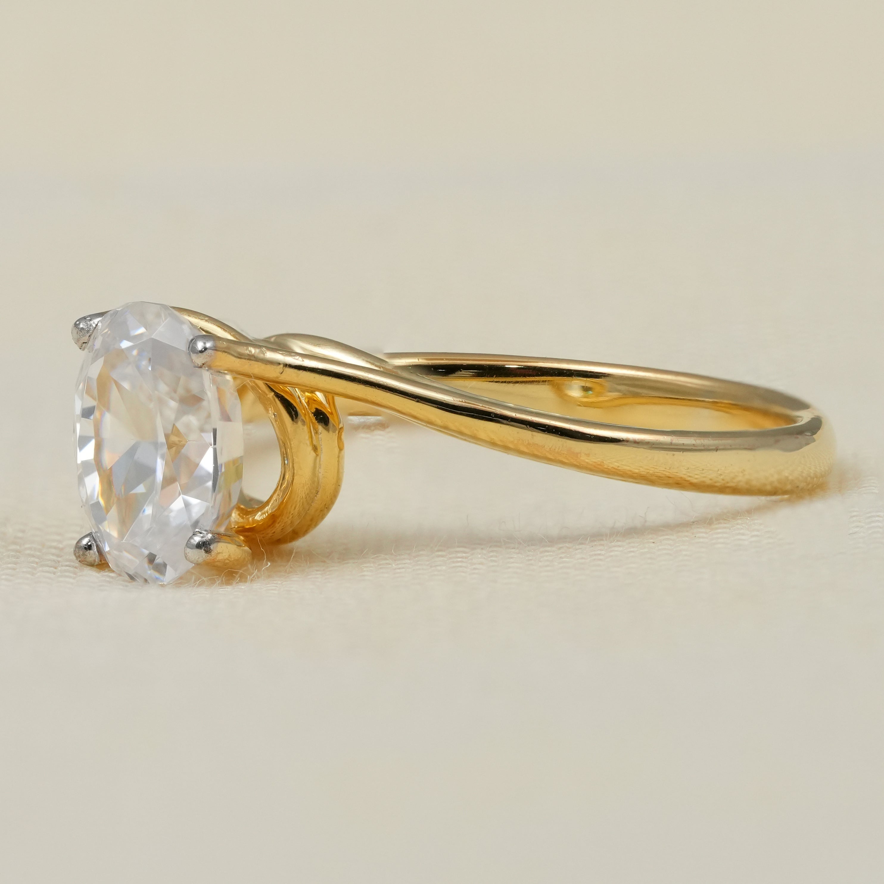 Minimal yellow gold oval lab grown diamond ring sculptural bypass design