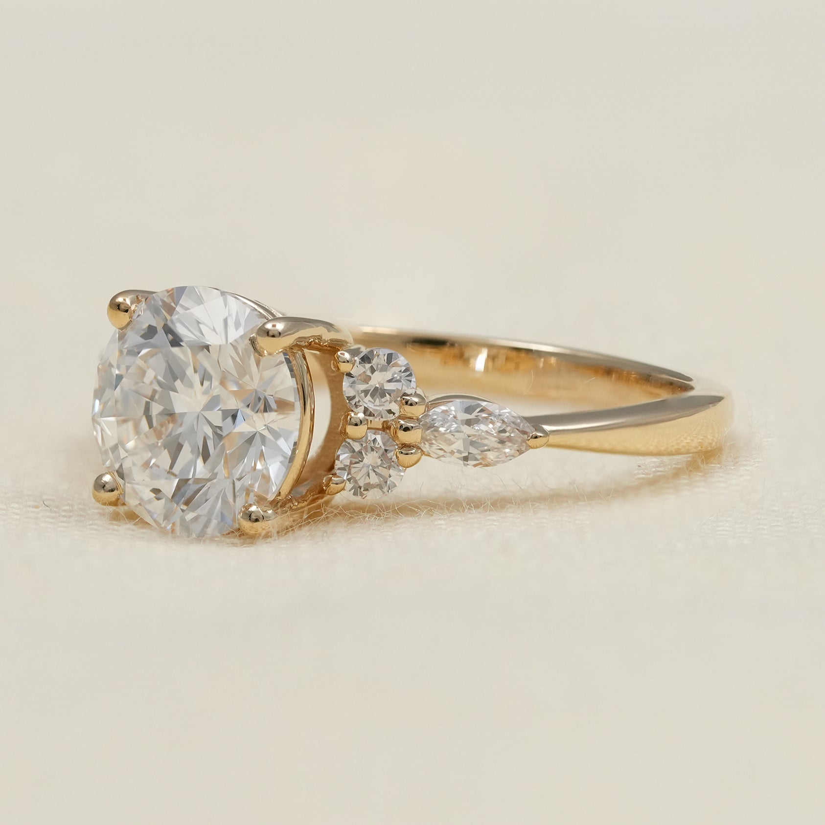 Round lab grown diamond ring with marquise and round accents