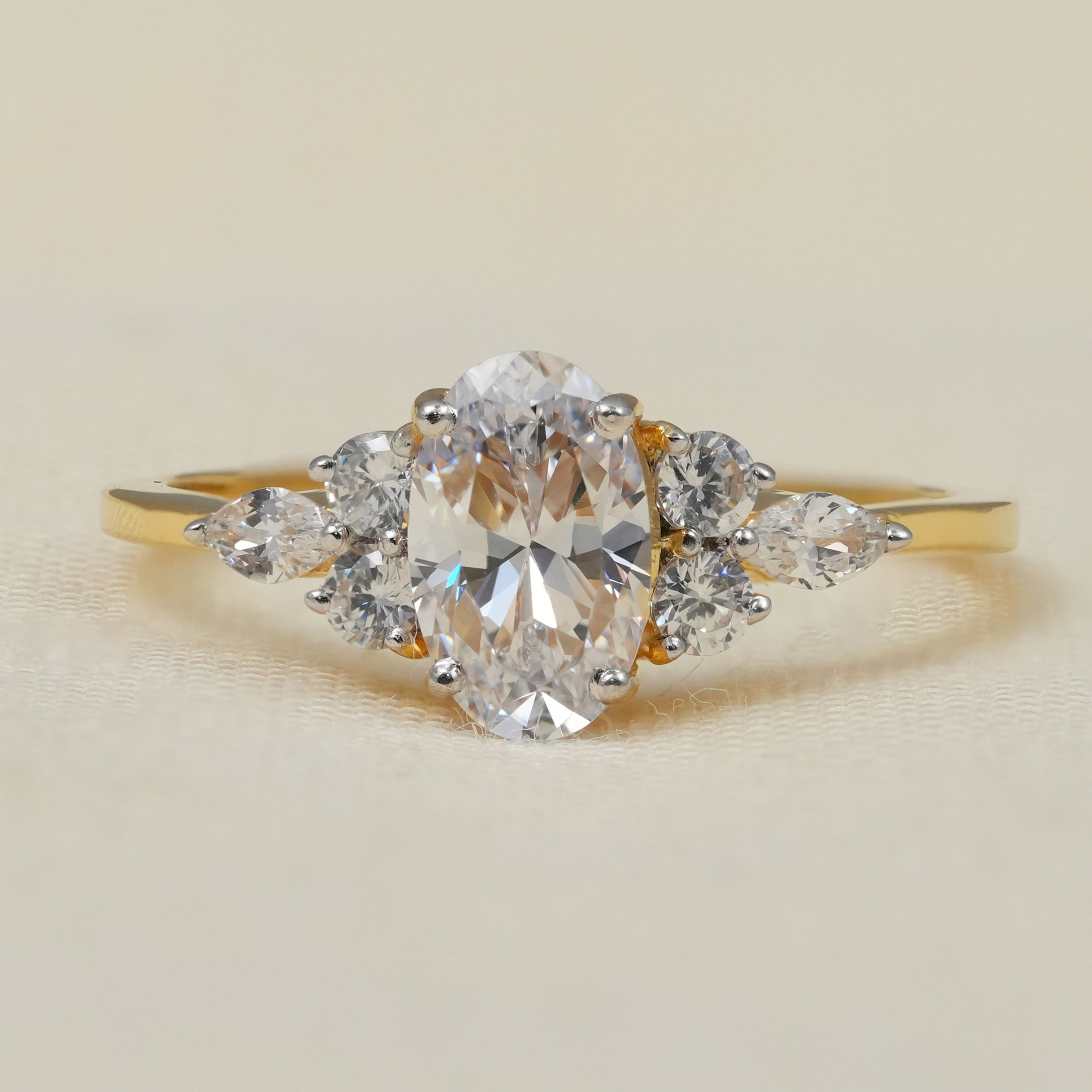 Oval lab grown diamond engagement ring with marquise cluster side stones