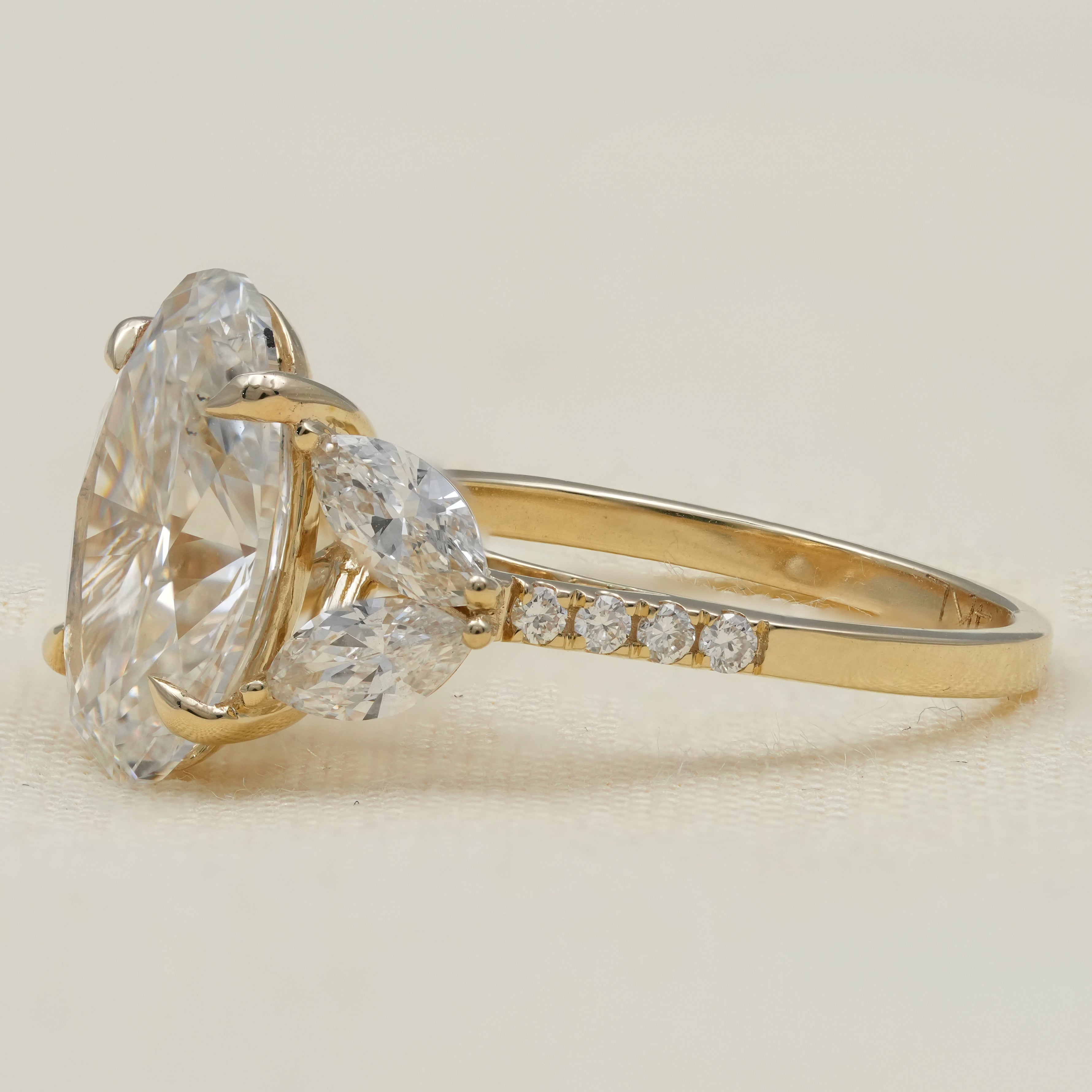 Luxury oval lab grown diamond three stone ring in yellow gold