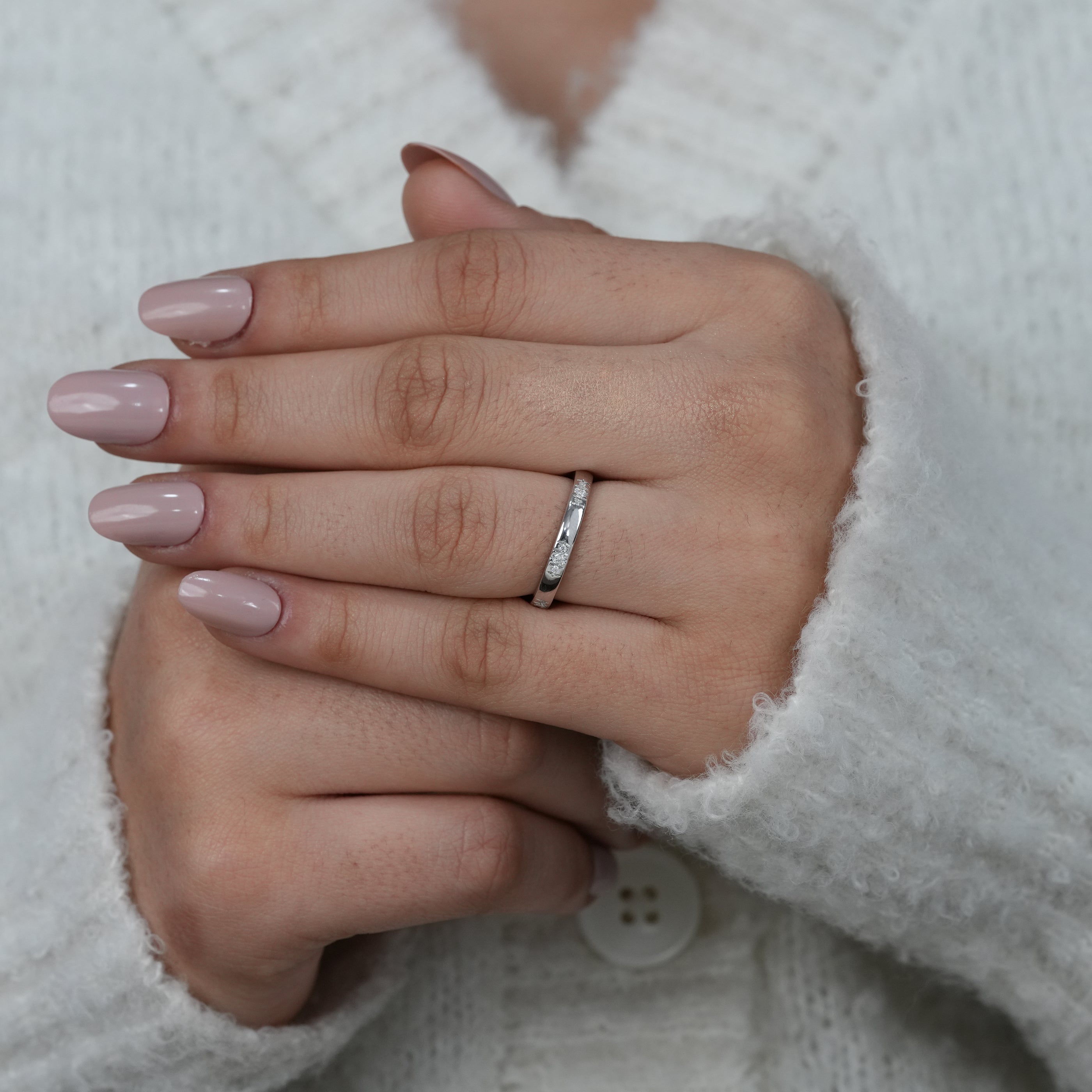 Simple white gold band with spaced round diamond settings