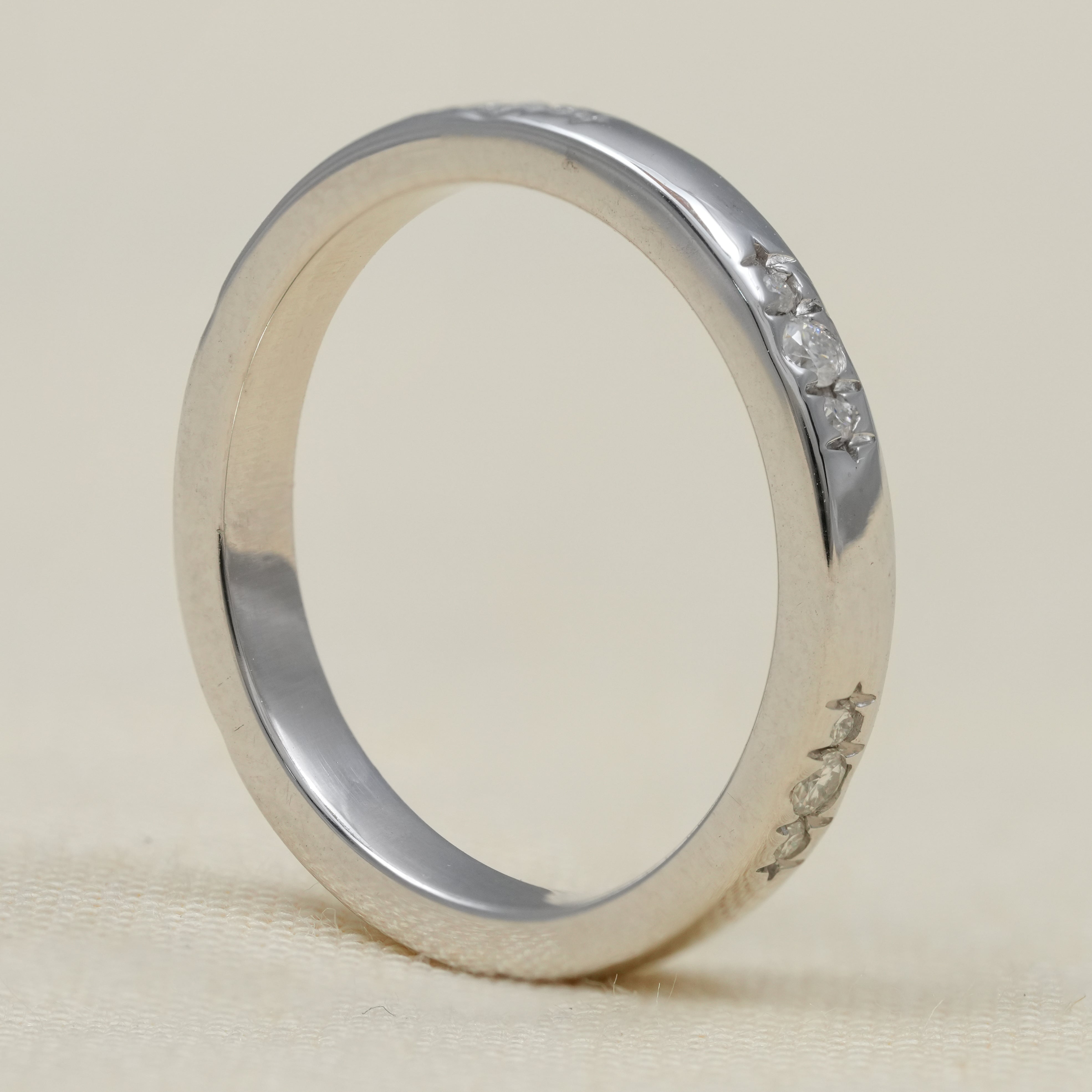 Modern white gold wedding band with flush set diamonds