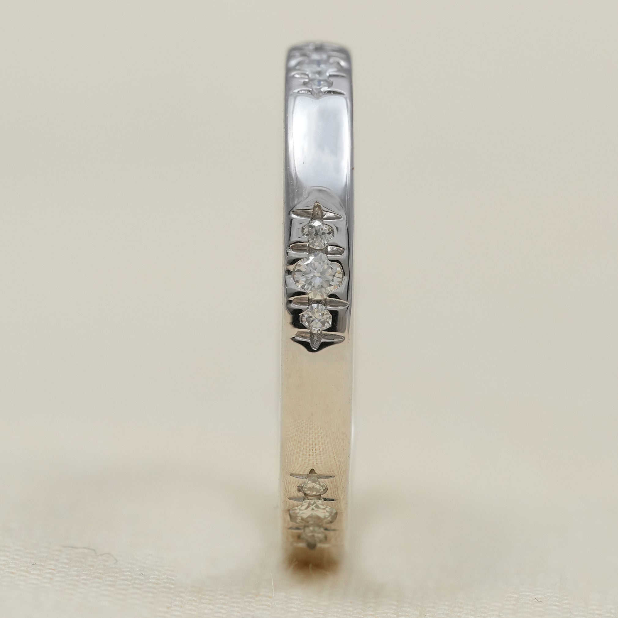 Contemporary flush set diamond band in white gold