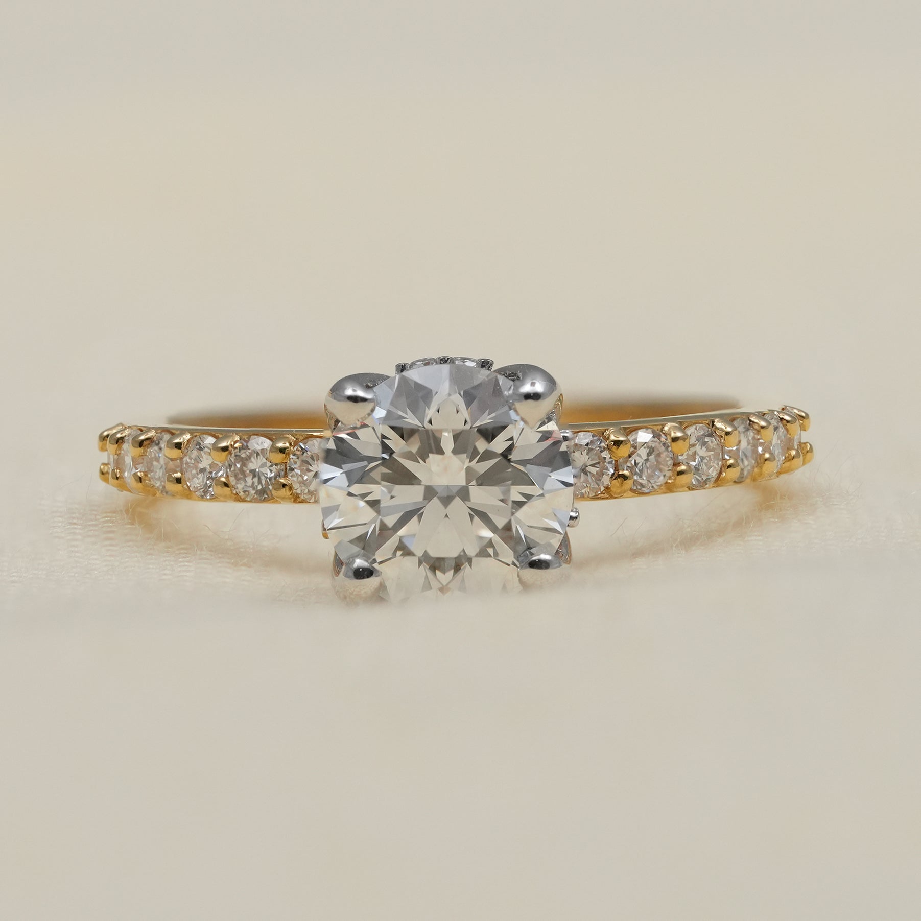 Round lab grown diamond engagement ring with yellow gold pavé band