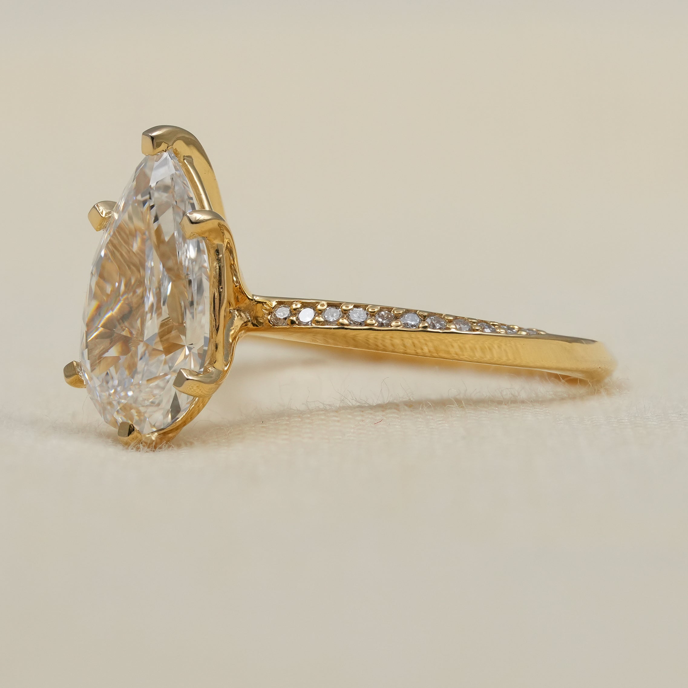 Yellow gold solitaire ring with pear lab grown diamond and pavé band