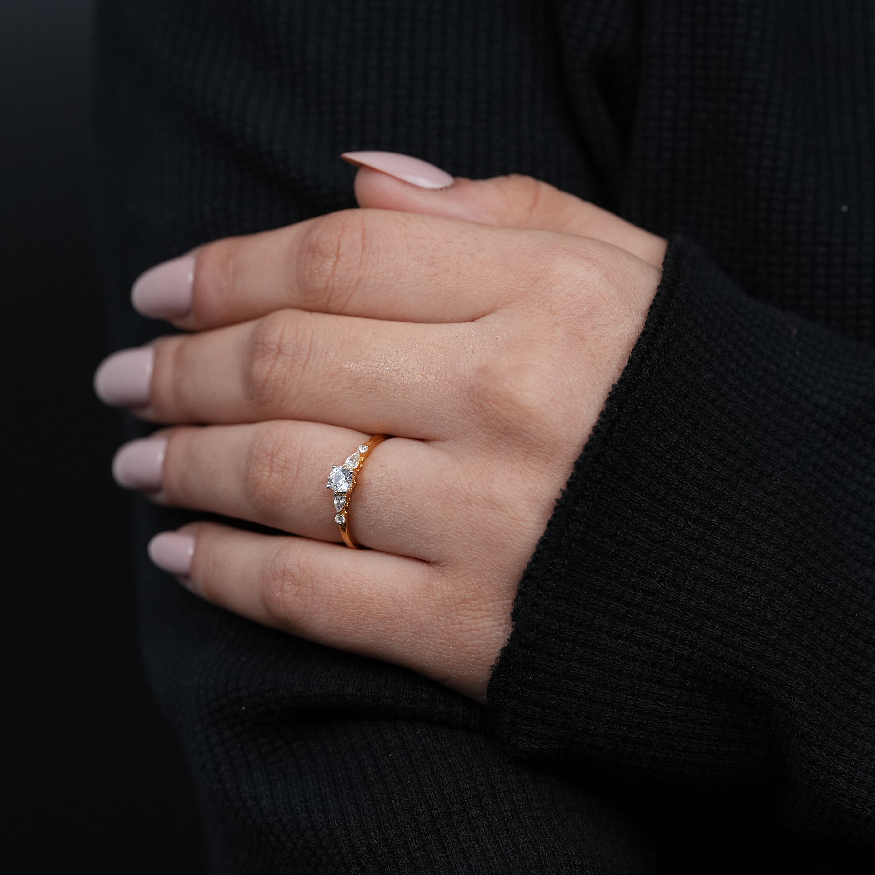 Timeless round lab grown diamond ring with pear shaped side stone detailing