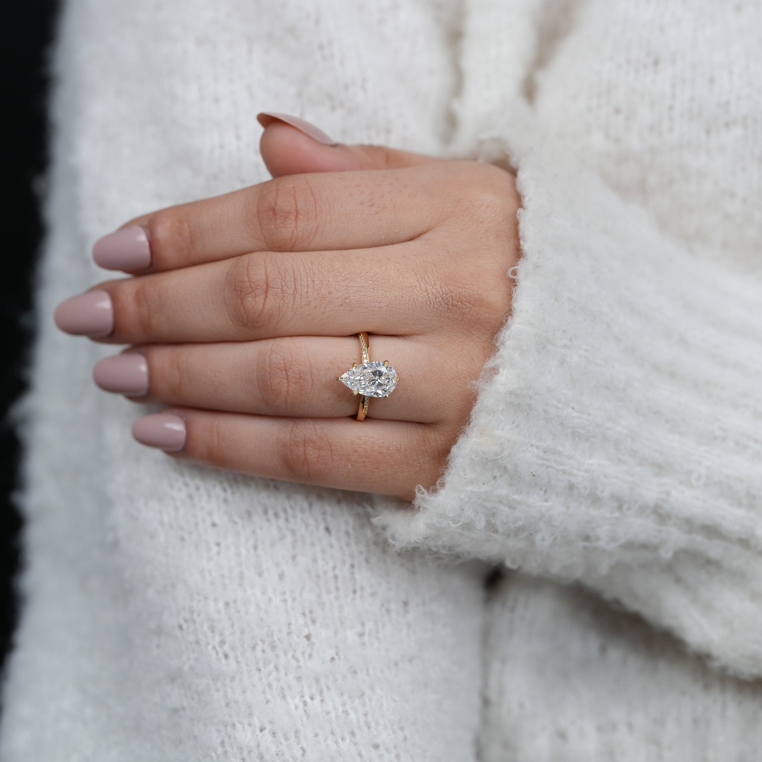 Minimal yellow gold engagement ring with pear lab grown diamond center