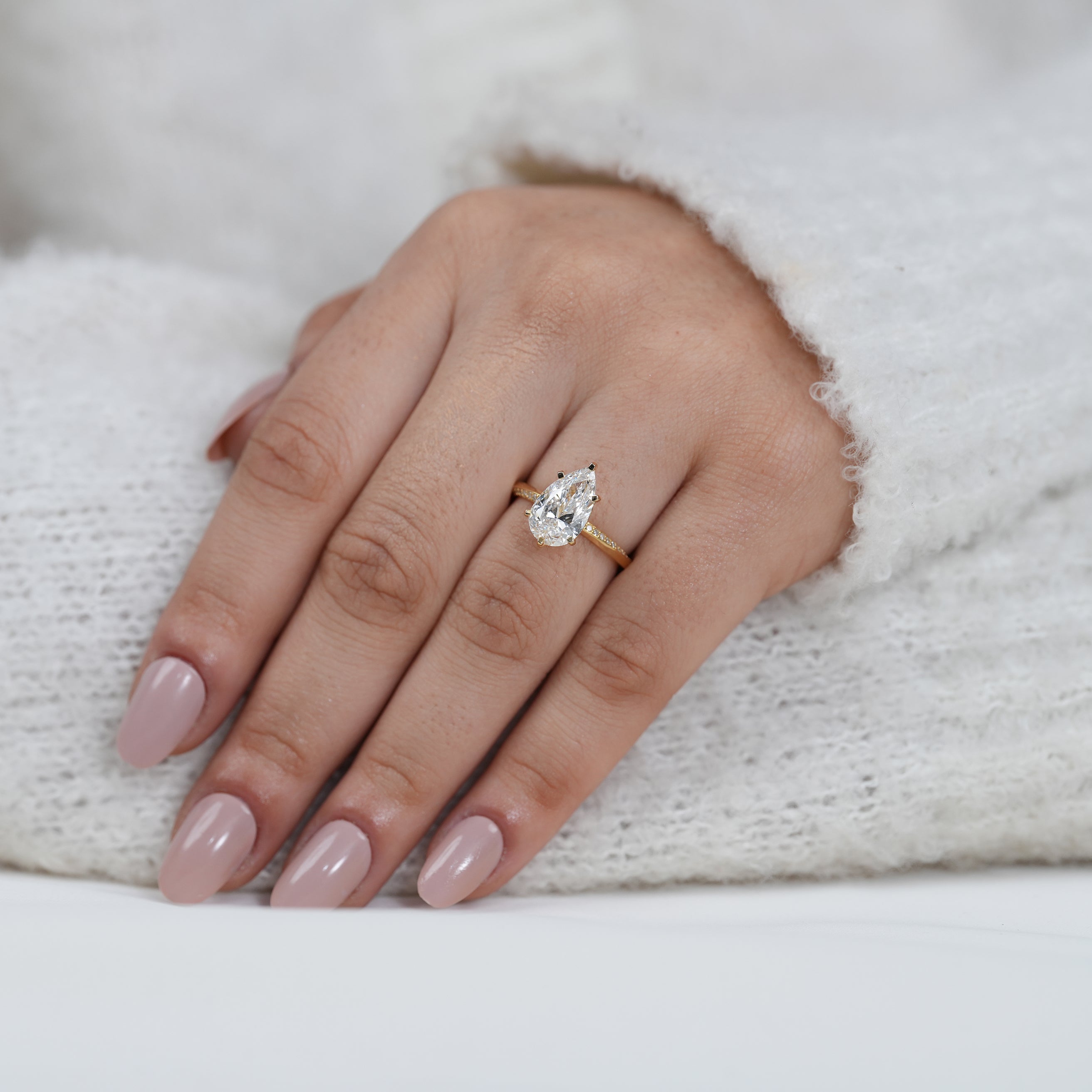 Fine pear shaped lab grown diamond ring with polished yellow gold band