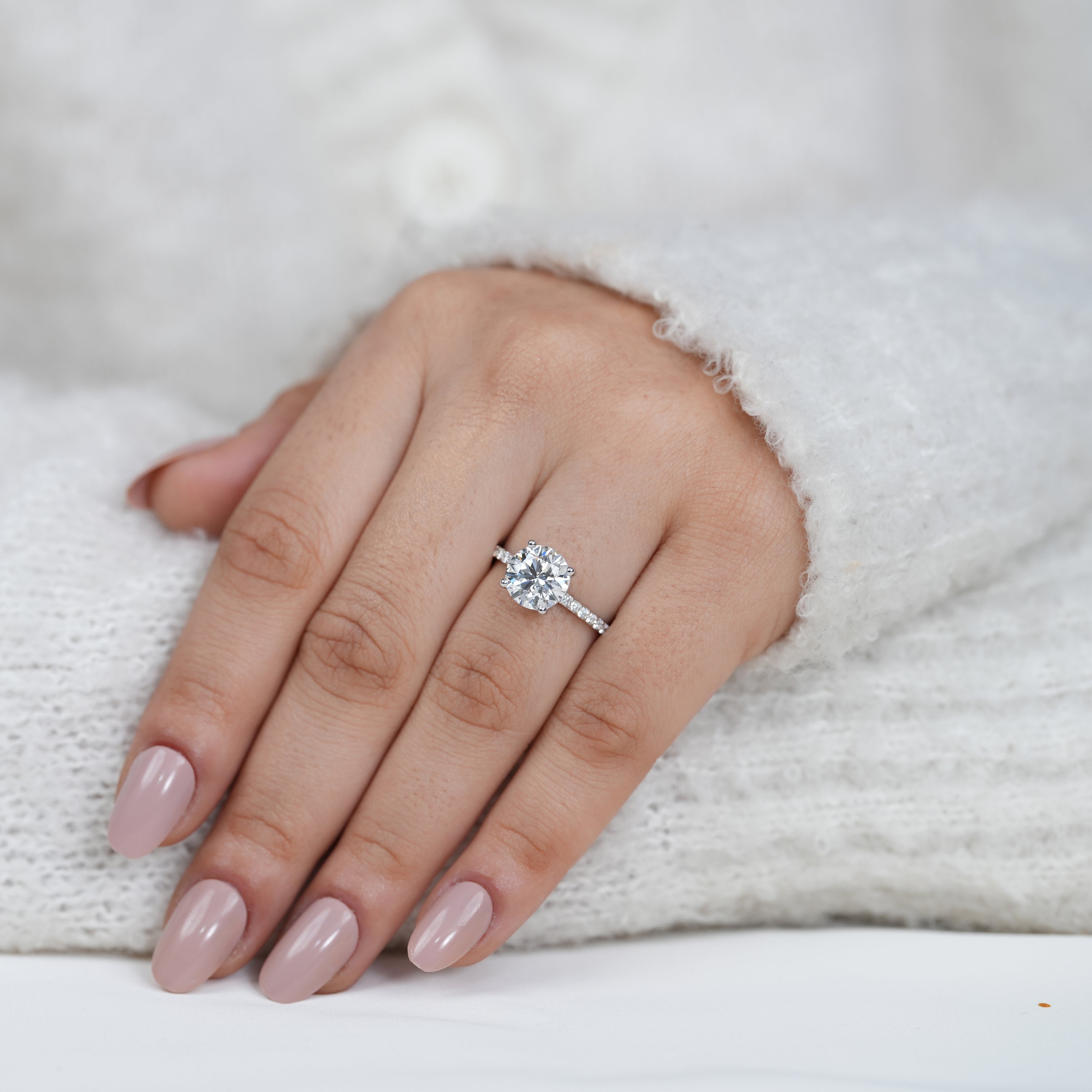 Classic four prong round diamond ring with pavé setting