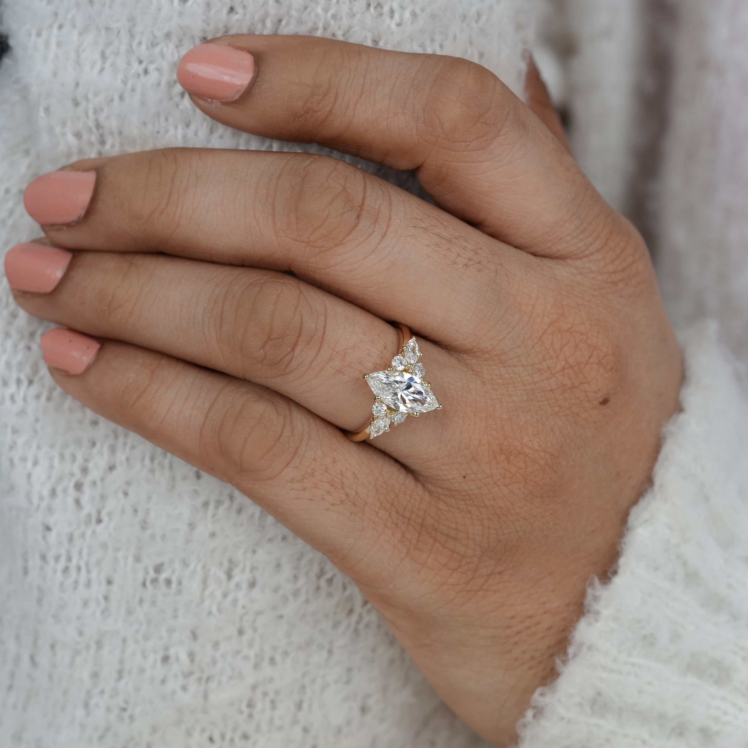 Close up marquise lab grown diamond ring with decorative sides