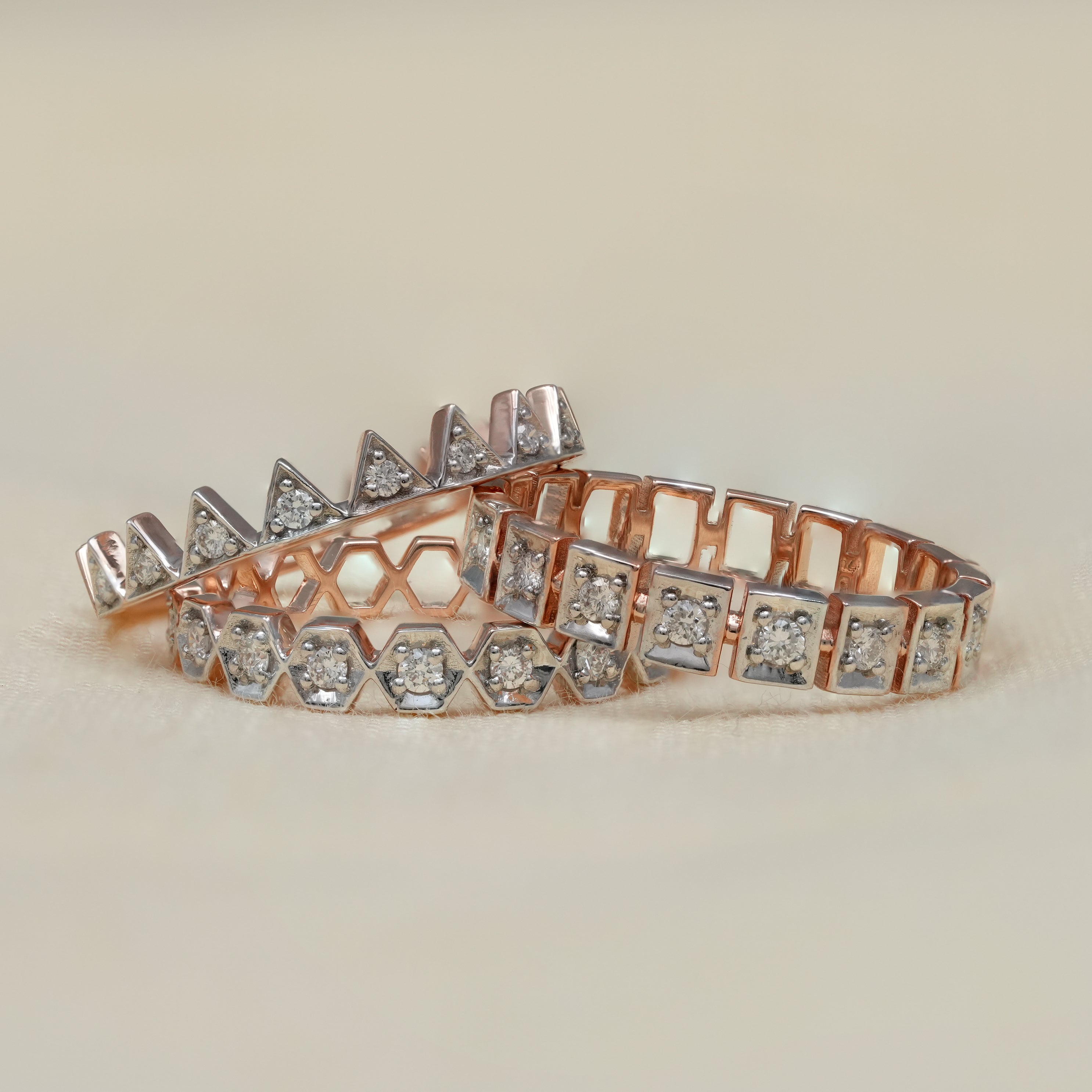 Two tone crown stackable diamond rings with geometric pattern