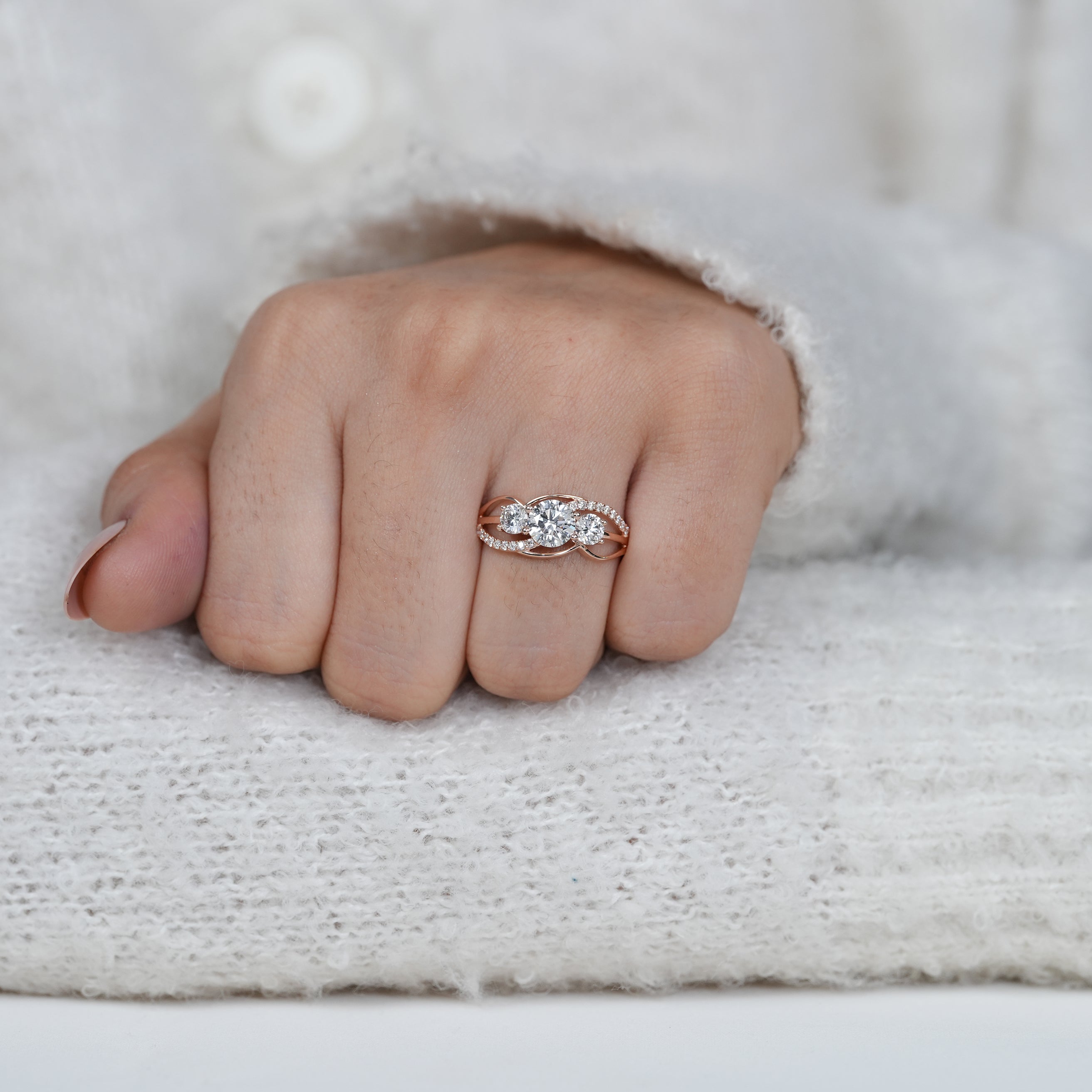 Fine three stone lab grown diamond ring with rose gold swirl band