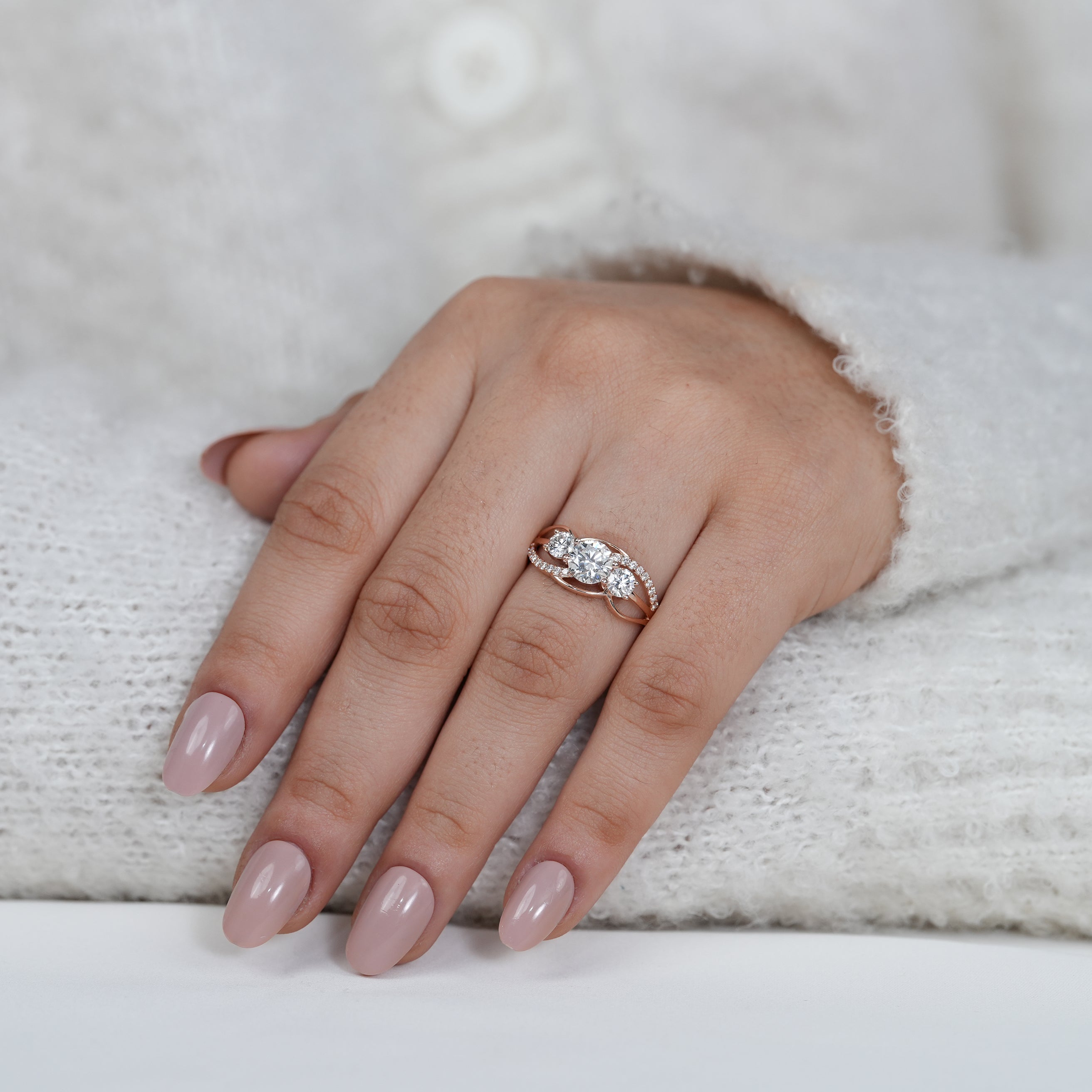 Romantic rose gold engagement ring with round lab grown diamond trio