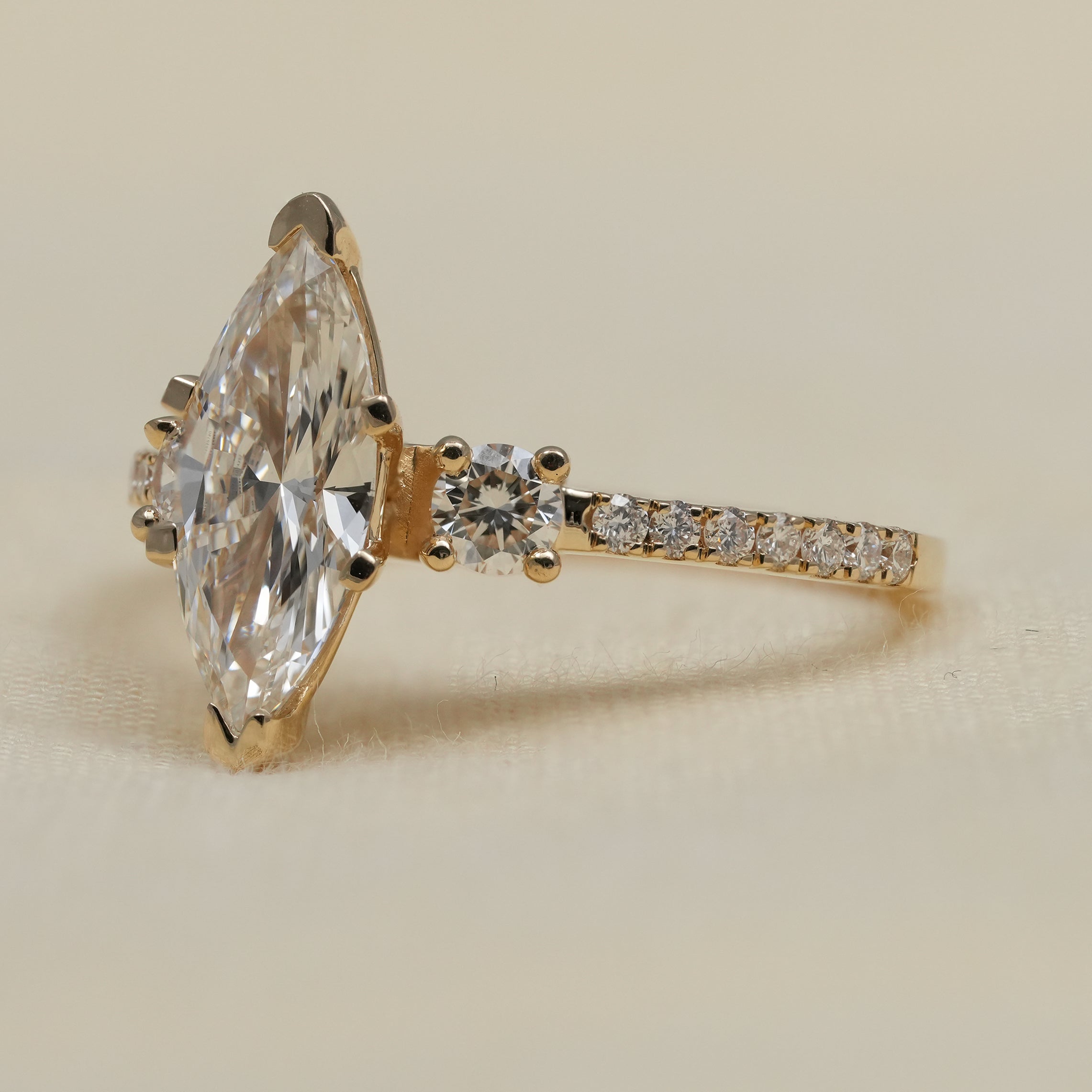 Three stone marquise lab grown diamond ring in yellow gold