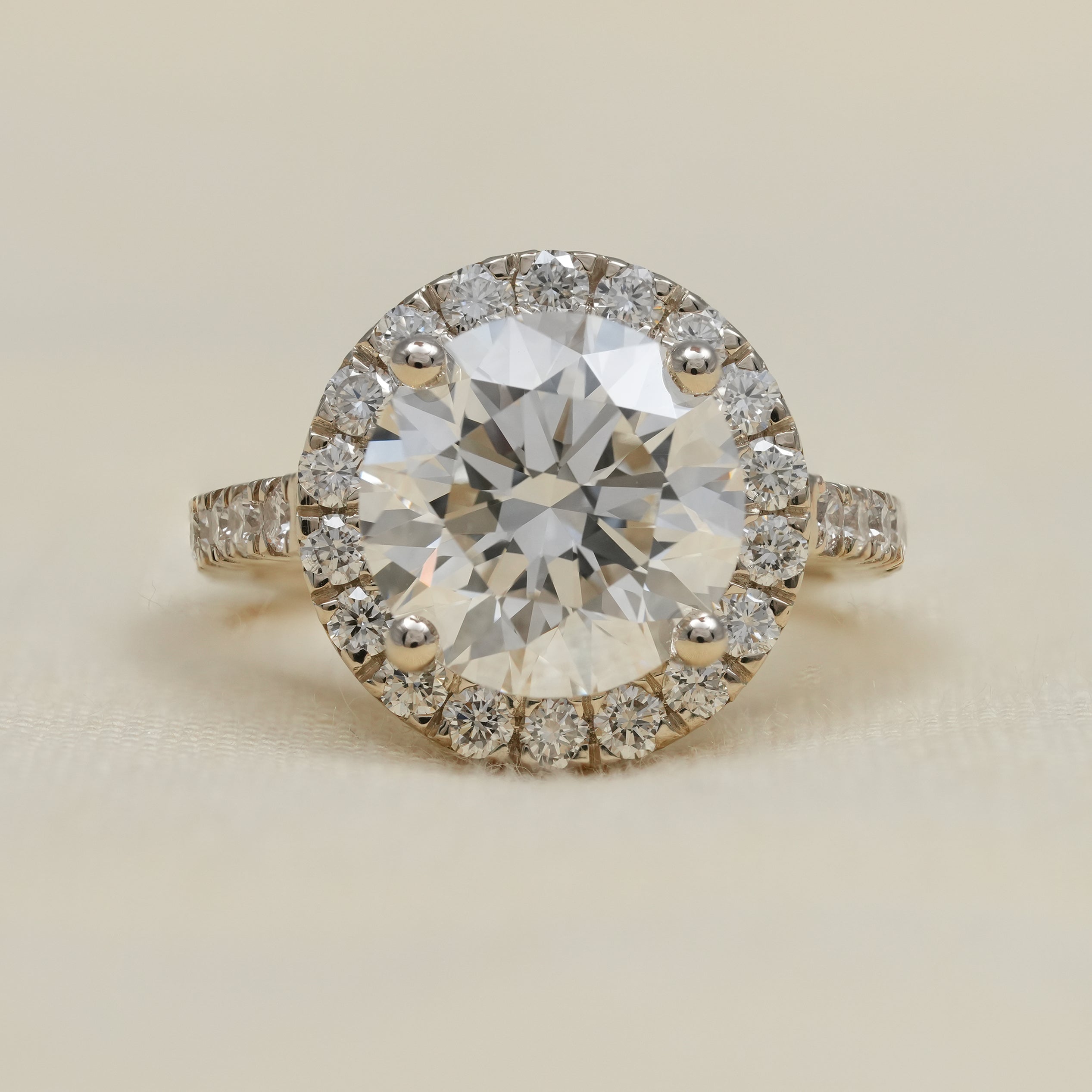 Round lab grown diamond halo ring with yellow gold pavé band