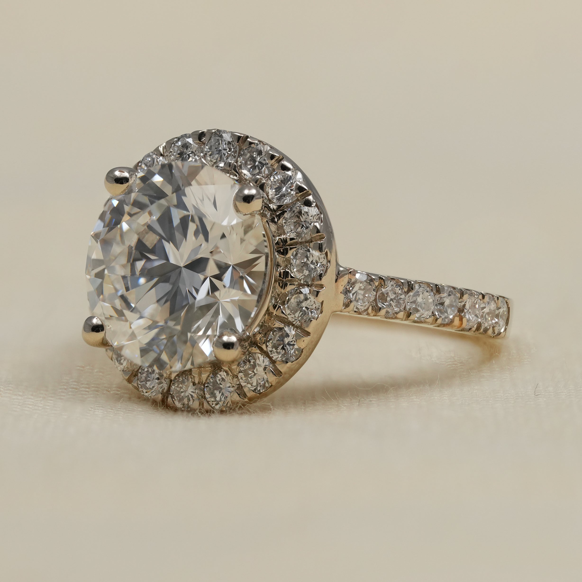 Classic halo ring with round lab grown diamond and pavé shank