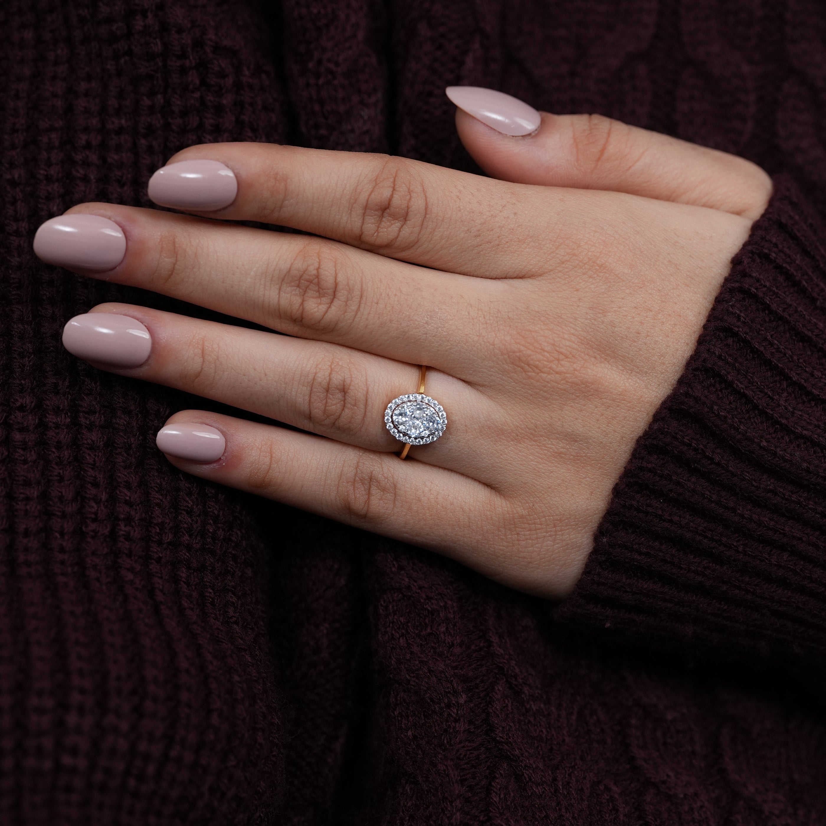 Classic oval diamond cluster ring with halo setting in yellow gold
