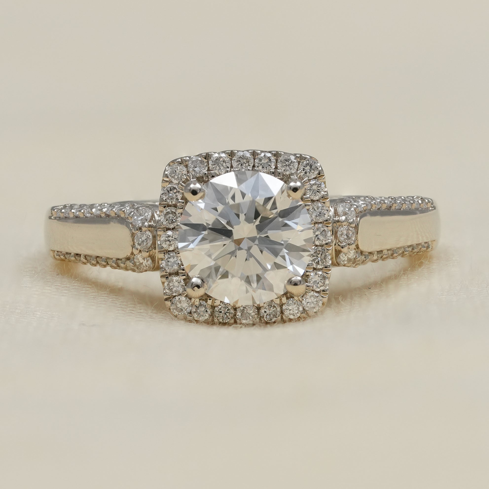 Round lab grown diamond halo engagement ring with pavé white gold band