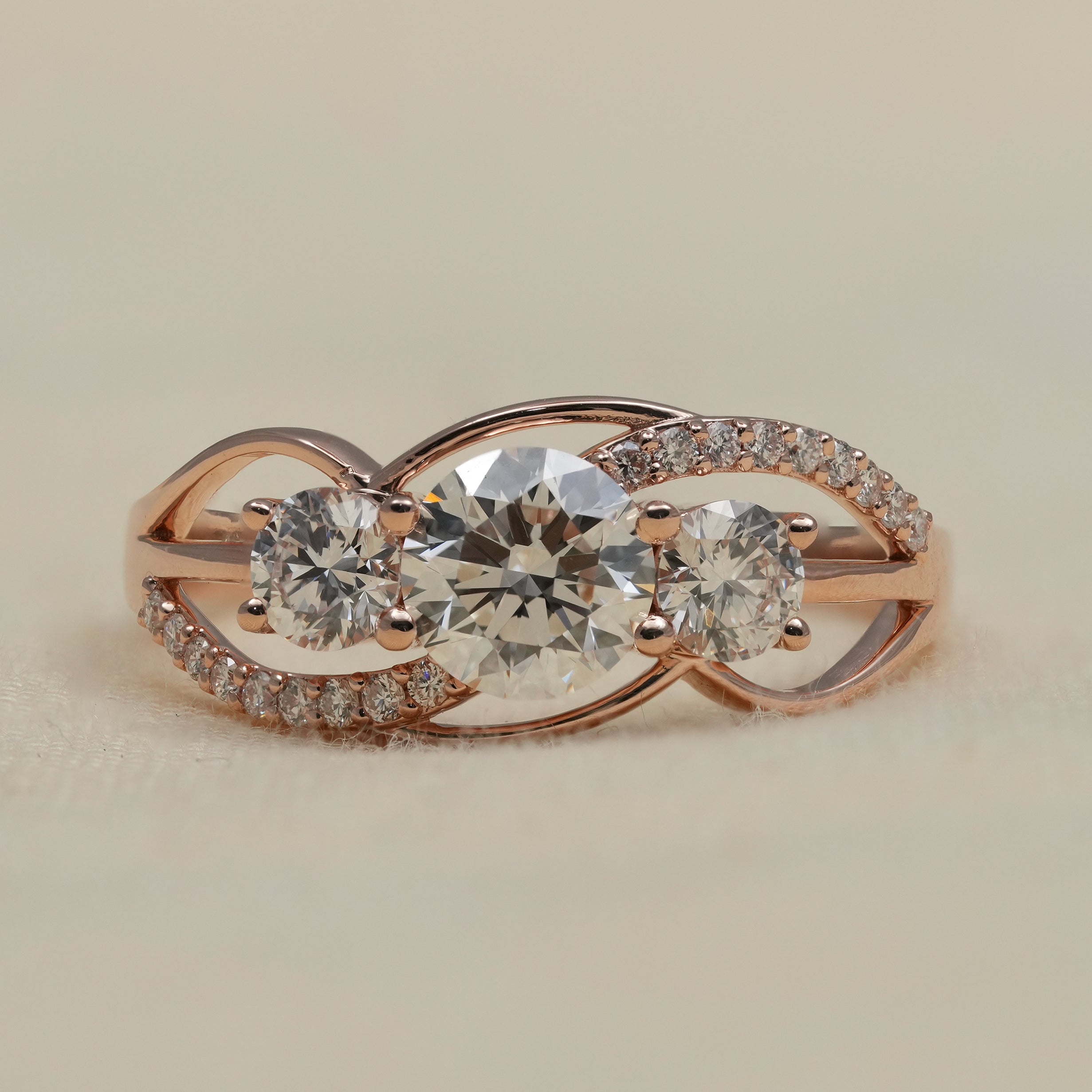 Three stone lab grown diamond ring in rose gold twist band