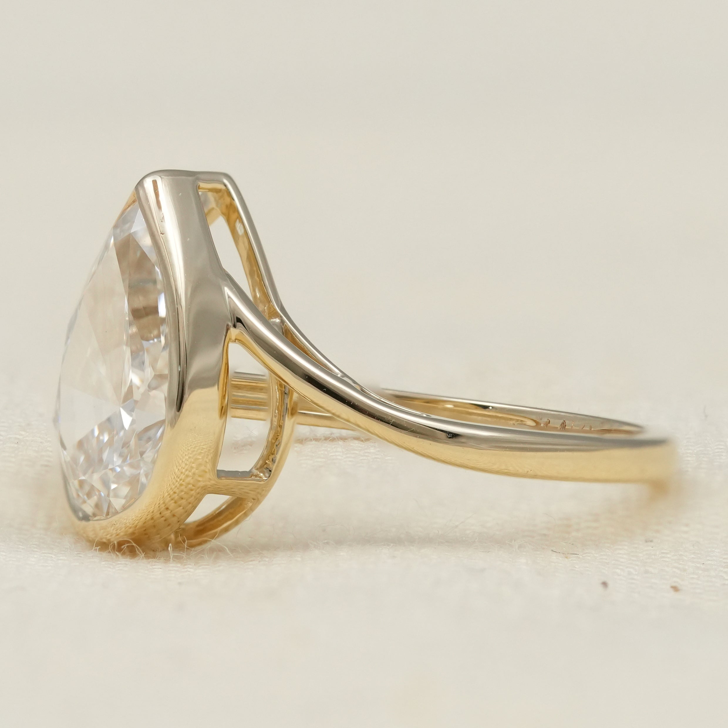Minimalist pear lab grown diamond bezel style bypass engagement ring