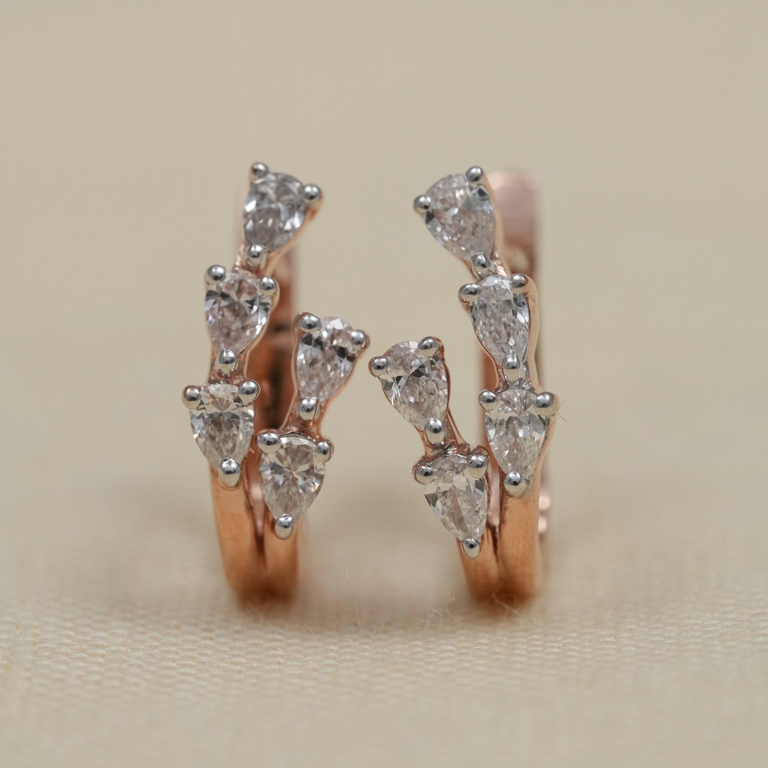 Close up pear lab grown diamond rose gold huggie earrings